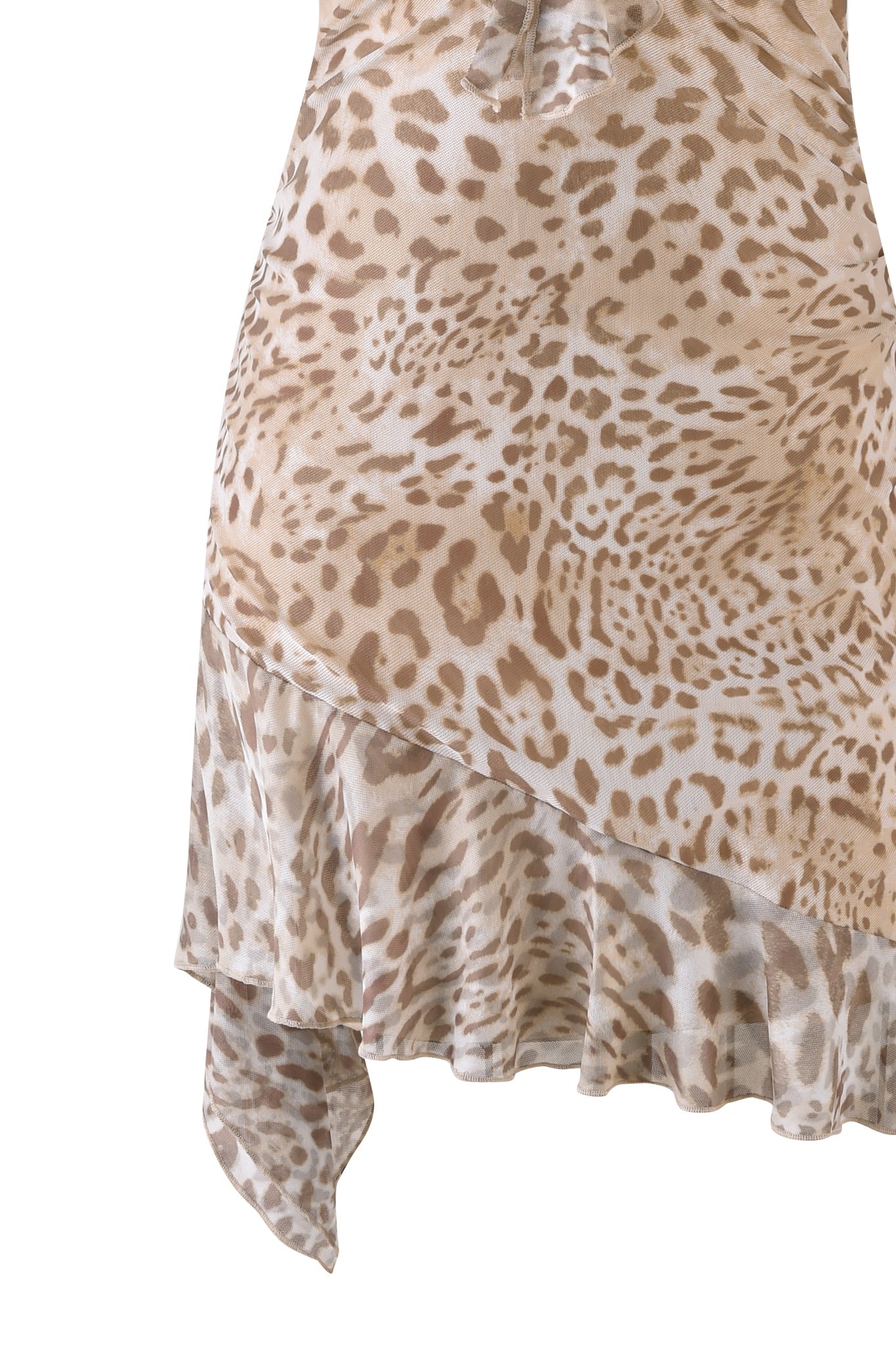 Detailed view of the I.AM.GIA VIRA MINI DRESS - NEUTRAL : ANIMAL : JAGUAR, featuring an asymmetrical hemline with a striking beige and brown jaguar print. The lightweight fabric drapes elegantly, emphasizing the bodycon silhouette.