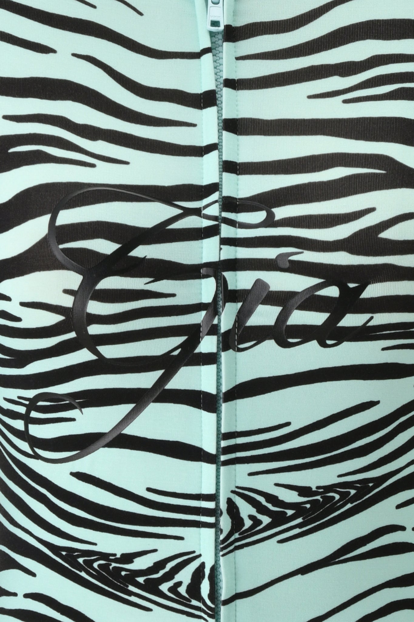 Close-up of the BLARE HOODIE - AQUA FINE LINE ZEBRA by I.AM.GIA, featuring mint green fabric with black zebra stripes and a center zipper. The word “Gia” is written in cursive across the fabric.