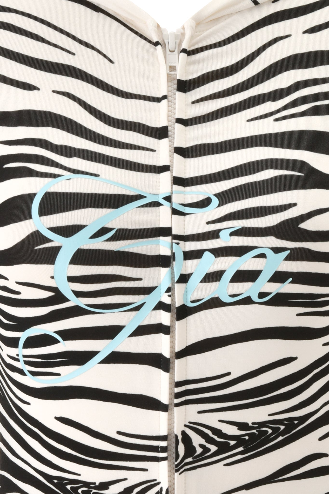Close-up of the I.AM.GIA BLARE HOODIE - FINE LINE ZEBRA, featuring a black and white zebra print with a front zipper and “Gia” written in light blue cursive across the front, showcasing the brand’s signature style.