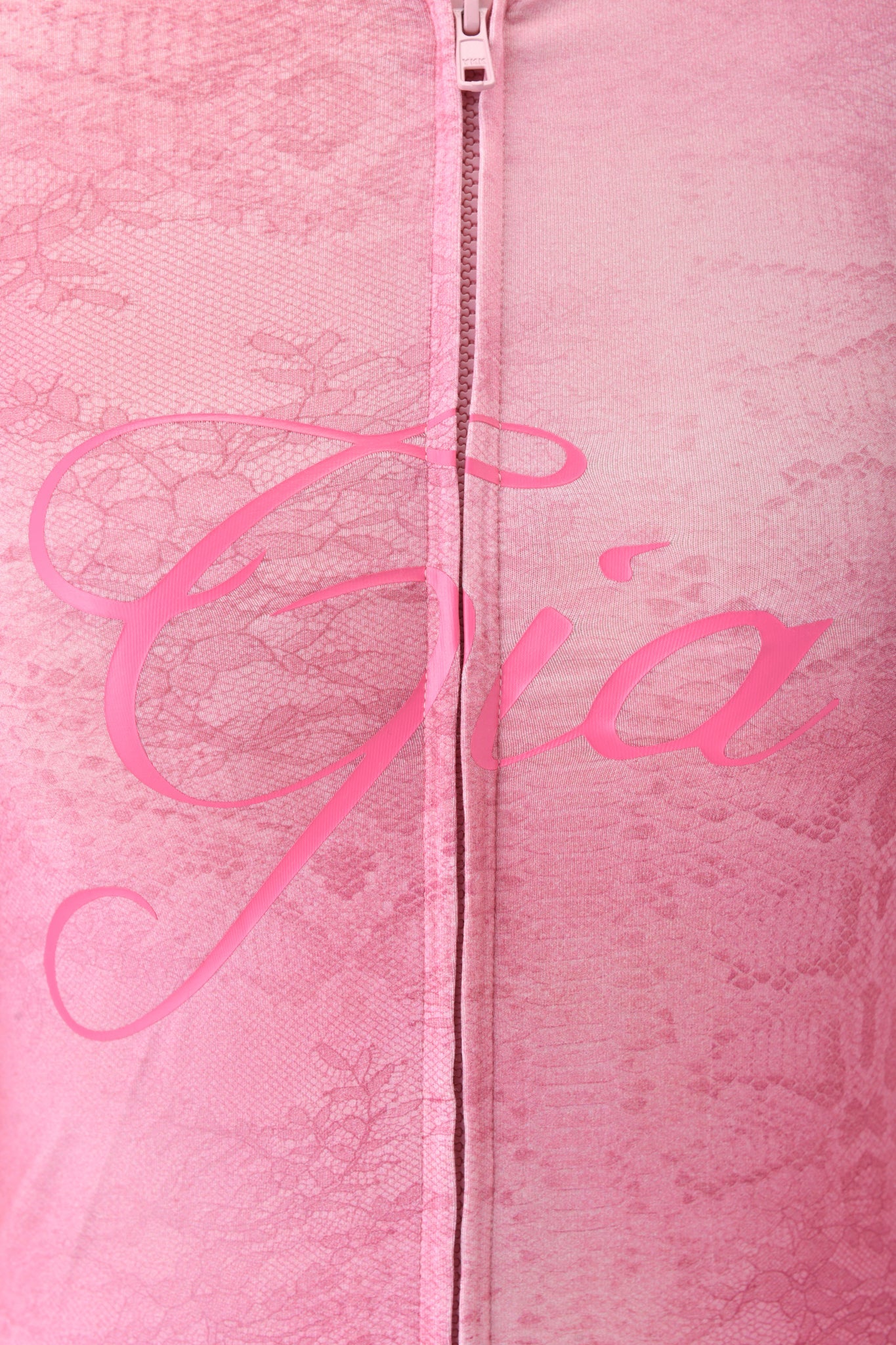 Close-up of the BLARE HOODIE - LIGHT PINK SERPENTINE by I.AM.GIA, showing pink lace fabric, a central zipper, and subtle brand detailing for a signature look.
