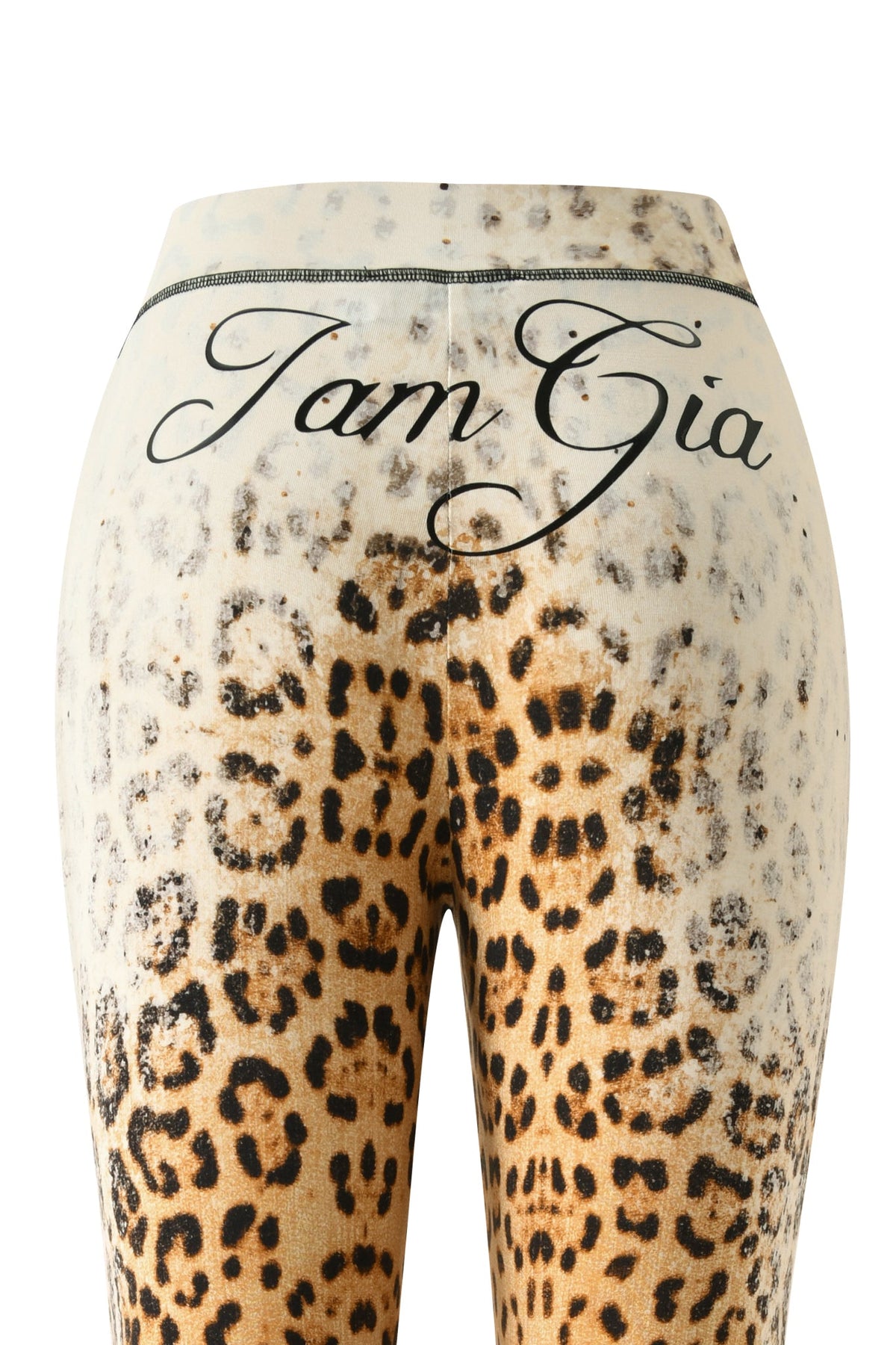 Close-up of the BLARE TRACKPANT - CREAM FADED PANTHERA by I.AM.GIA, featuring a bold animal-inspired print and the brand name showcased in black cursive across the waistband. These statement leggings highlight signature branding and an eye-catching cream faded panthera pattern for a standout look.