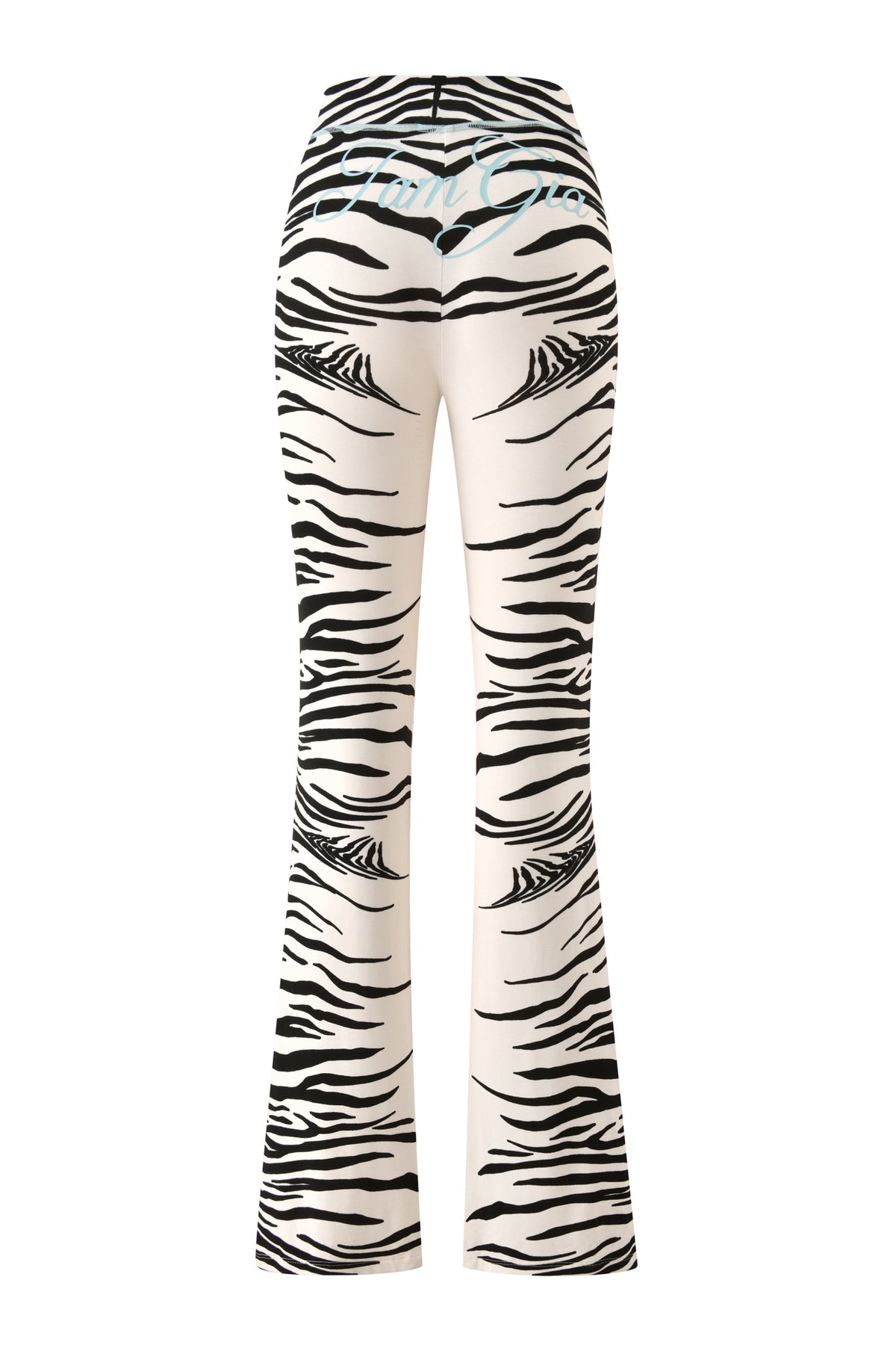 The I.AM.GIA BLARE TRACKPANT - FINE LINE ZEBRA features a striking black and white zebra print with a flared leg silhouette and “Fun Girl” emblazoned in light blue text across the back waistband, giving a playful update to the classic trackpant style.