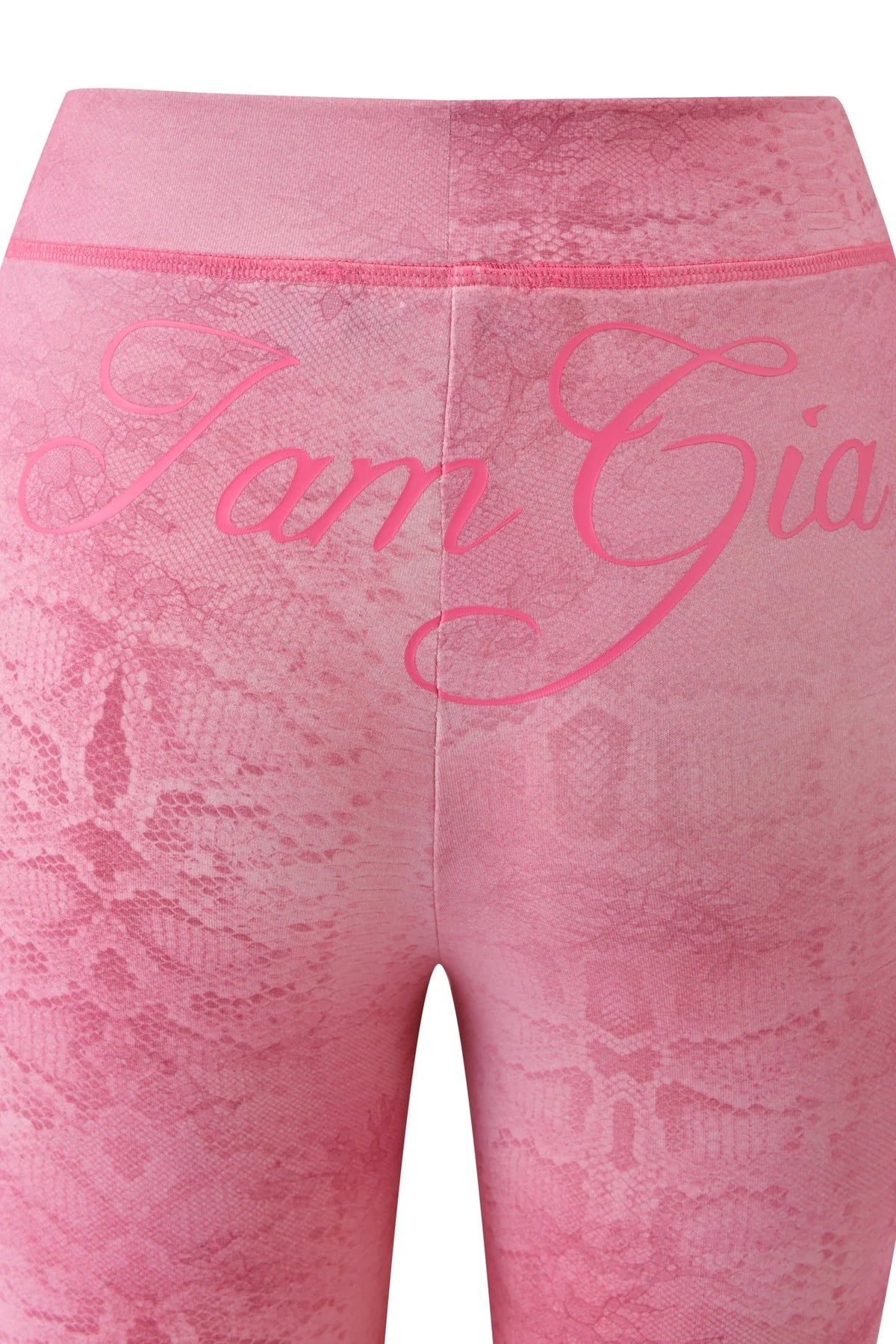 Close-up of the BLARE TRACKPANT in Light Pink Serpentine by I.AM.GIA, featuring a subtle serpentine print and “I.AM.GIA” in cursive on the waistband. The flared leg silhouette brings a modern update to this classic style.