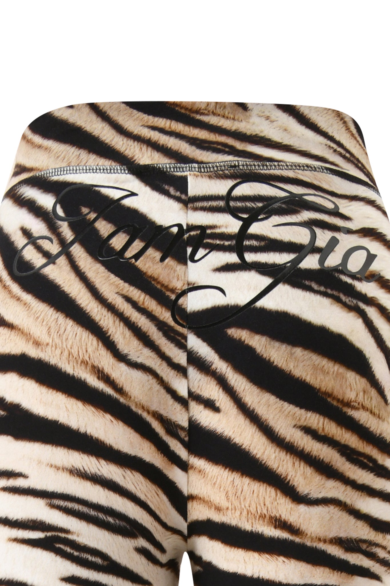 Close-up of the BLARE TRACKPANT - LIGHT TIGRESS featuring a bold "I.AM.GIA" logo in large black script across the waistband and upper back.