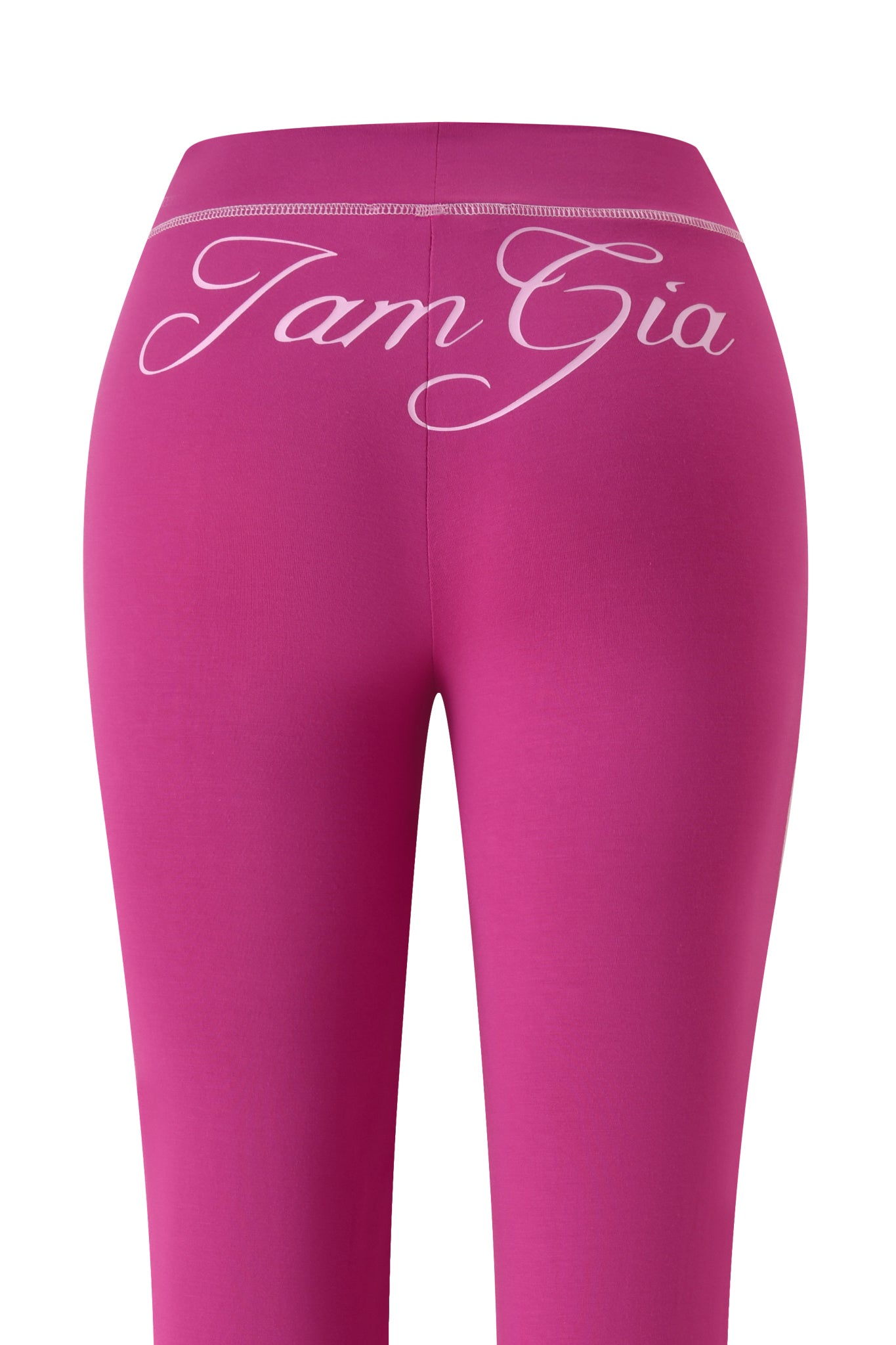The BLARE TRACKPANT - RASPBERRY by I.AM.GIA features "Tam Gia" in white cursive on the waistband, a raspberry hue, and a flattering flared leg silhouette.