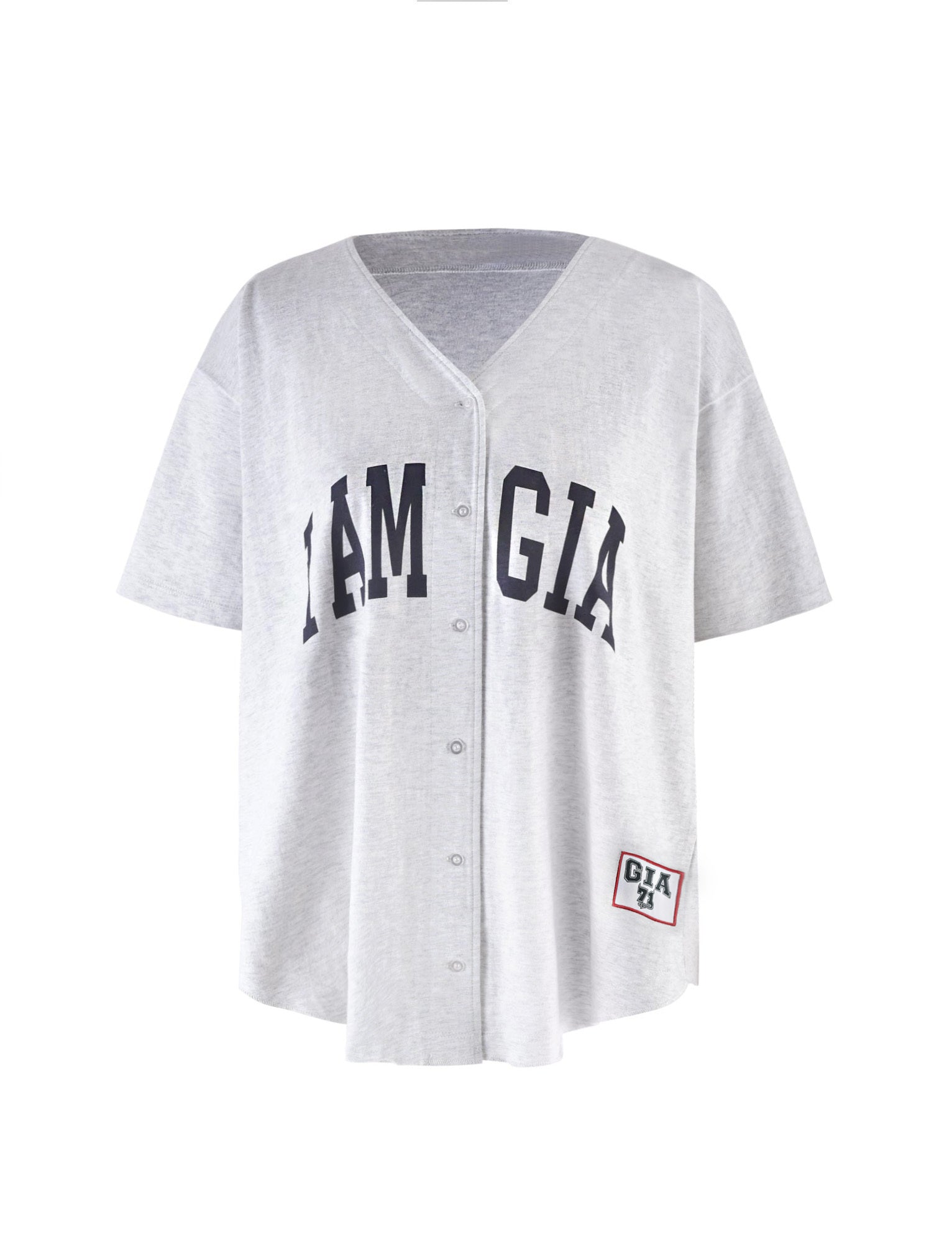 The LORRI JERSEY - GREY by I.AM.GIA is a light gray button-up baseball-style jersey featuring "I.AM.GIA" boldly emblazoned across the front. It showcases a V-neck design and includes a rectangular patch near the bottom with "GIA" on it. This short-sleeved, loose-fitting jersey embodies the distinctive style of I.AM.GIA.