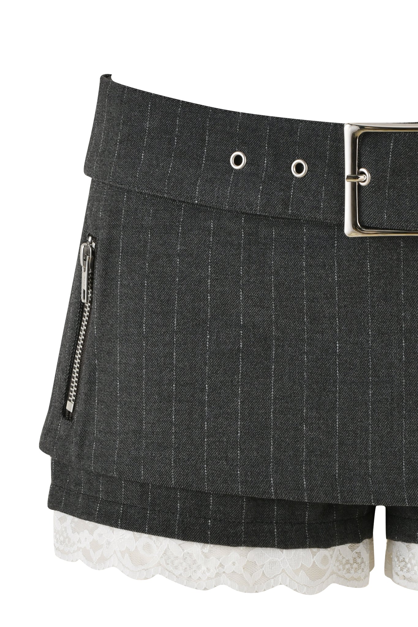 A close-up of the MARRION SKORT - GREY : PINSTRIPE by I.AM.GIA showcases a wide belt loop adorned with silver grommets and a prominent silver buckle. This skort features a small zipper pocket on the side, built-in shorts for enhanced comfort, and white lace trim subtly peeking out from beneath the hem.