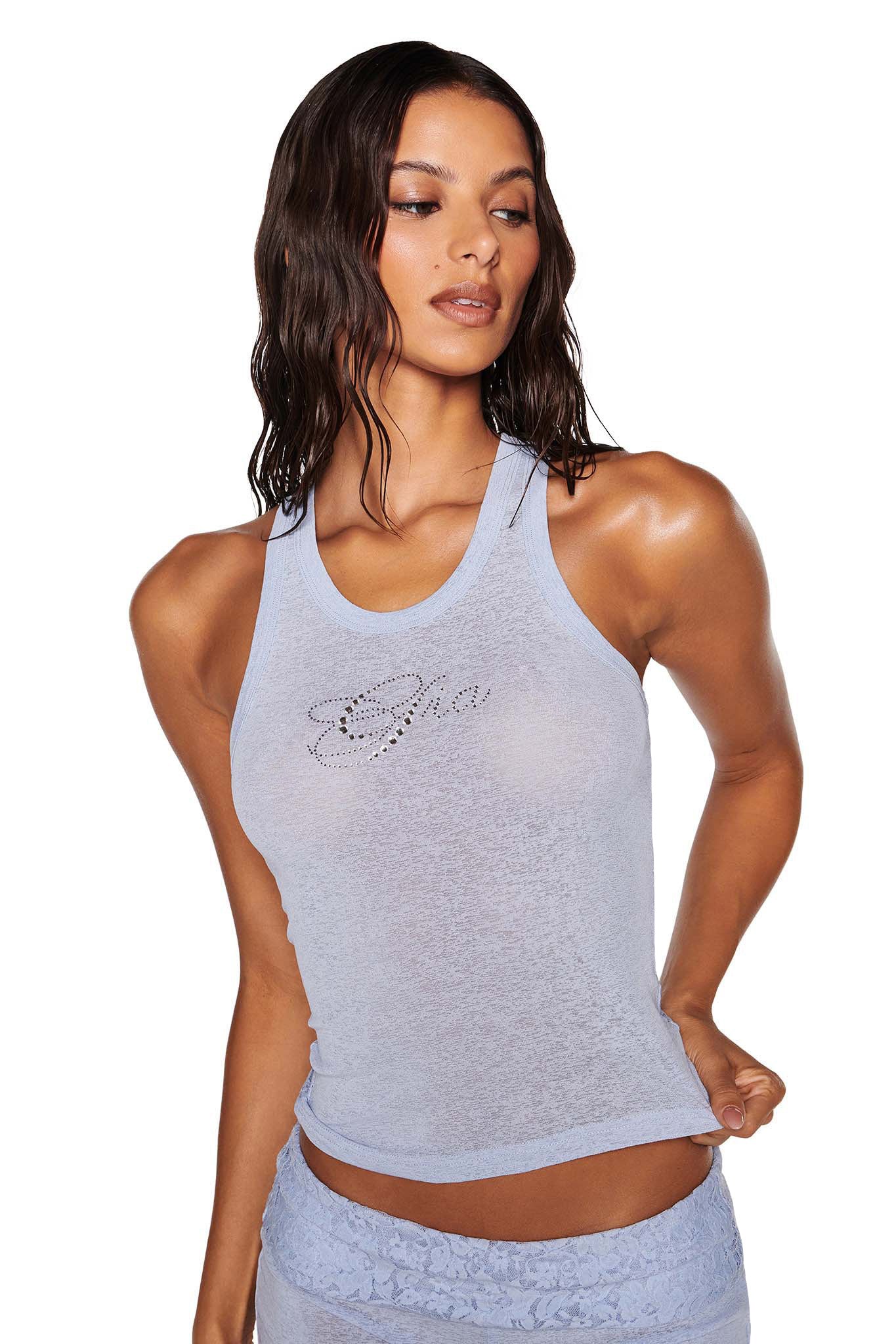 The individual is wearing a baby blue HURLEY TOP by I.AM.GIA with matching lace bottoms. Their wet, wavy hair falls over their shoulders against a plain white background.