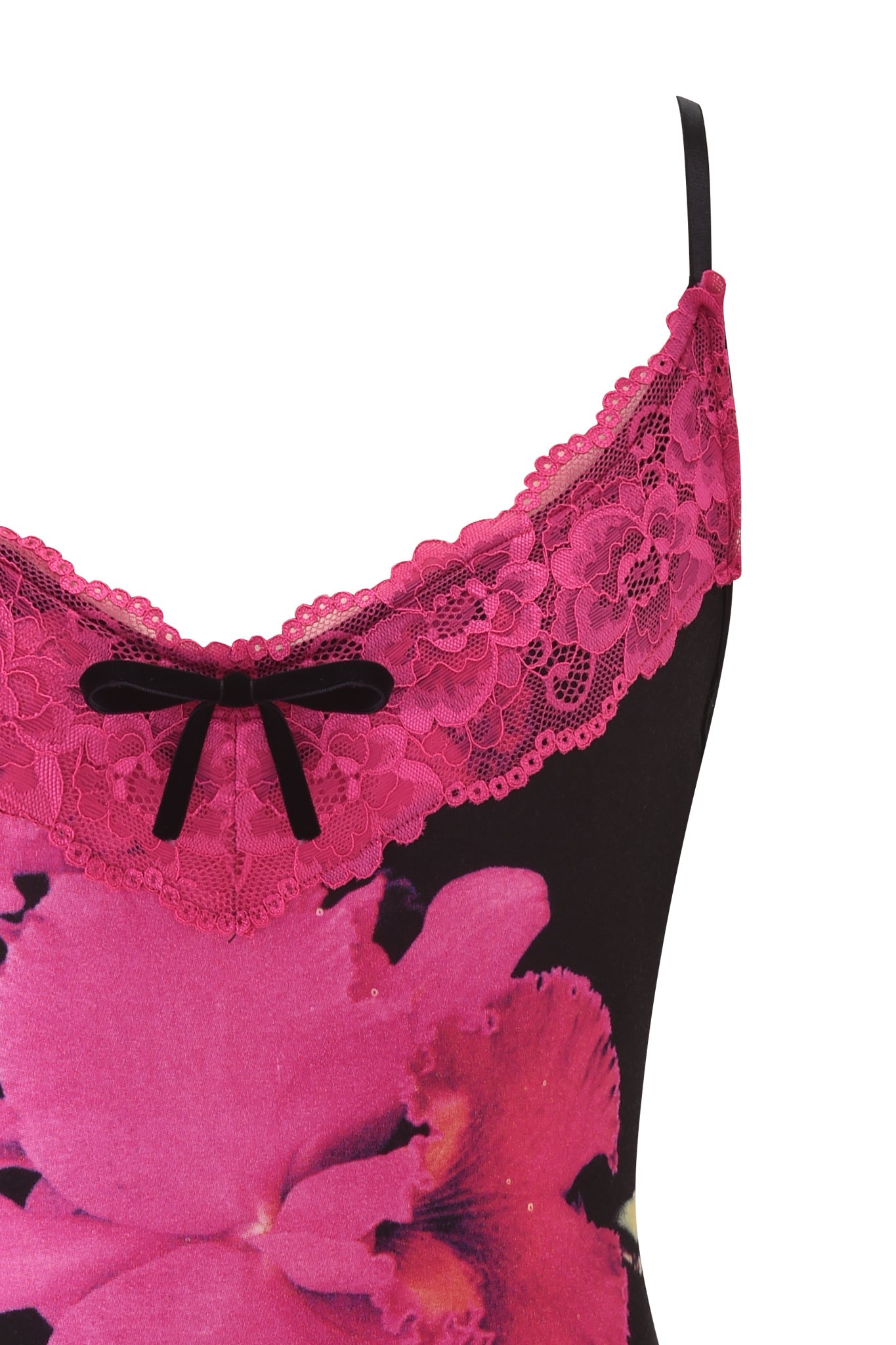 Close-up of the I.AM.GIA ADELLA TOP - FUCHSIA, showcasing pink lace trim, a black bow at the neckline, and bold pink floral print on black fabric. Only the upper section and straps are shown.