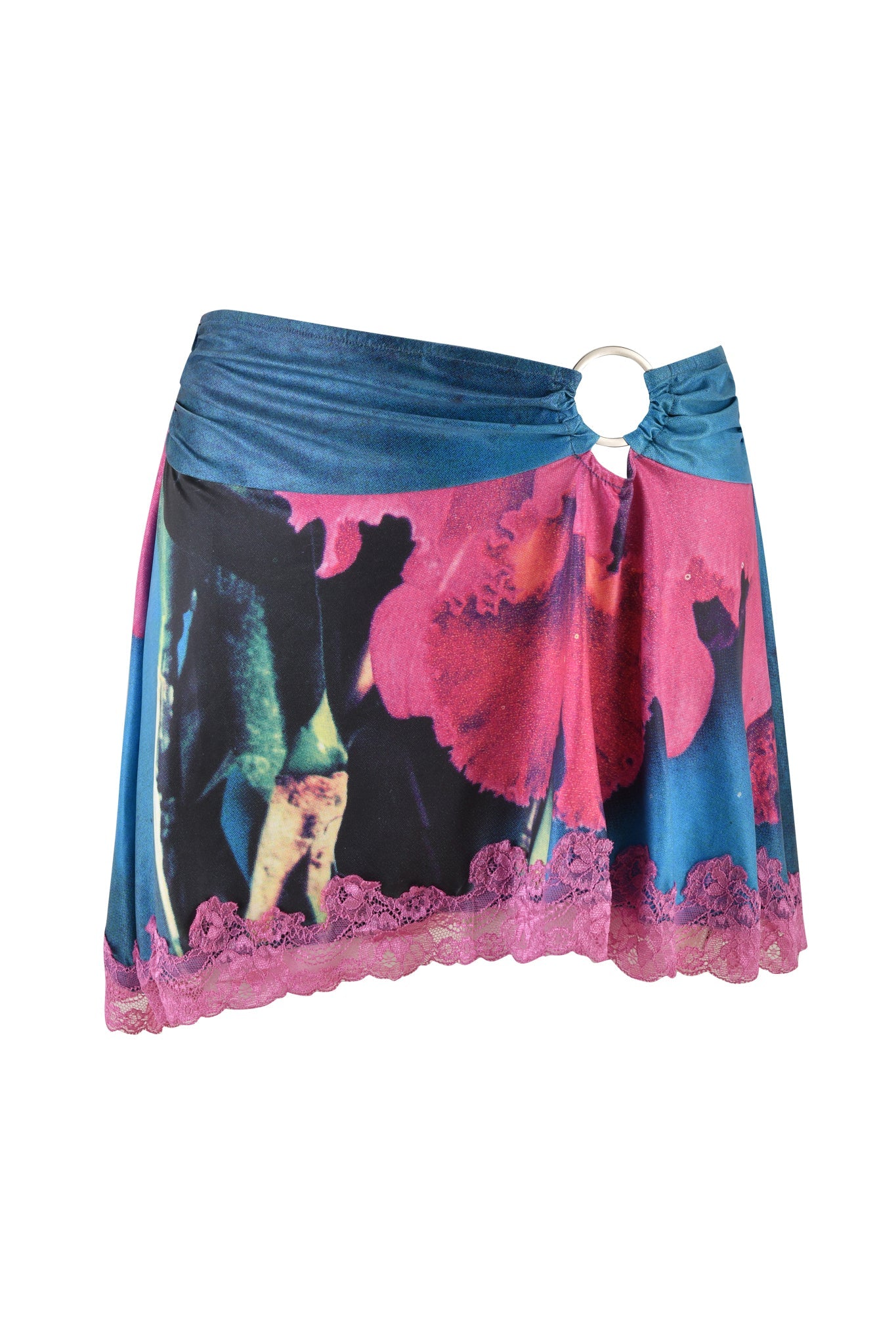 The ODETTA SKIRT - MULTI by I.AM.GIA is a short, asymmetrical skirt featuring a vibrant floral design in pink and blue hues. This mid-rise A-line silhouette includes a decorative ring on the waistband and lace trim along the hem, making it a chic addition to your wardrobe.