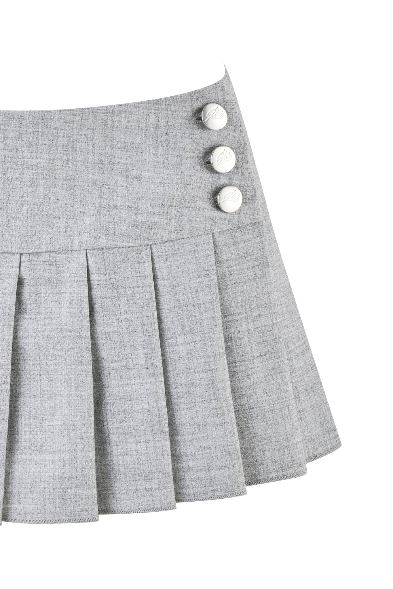 Close-up of the REMINI SKORT 2.0 in grey by I.AM.GIA, showcasing a light gray pleated design with a high waistline and three white buttons on the right side. The fabric features a subtle, textured pattern, blending classic detailing with modern style. The image is set against a white background.