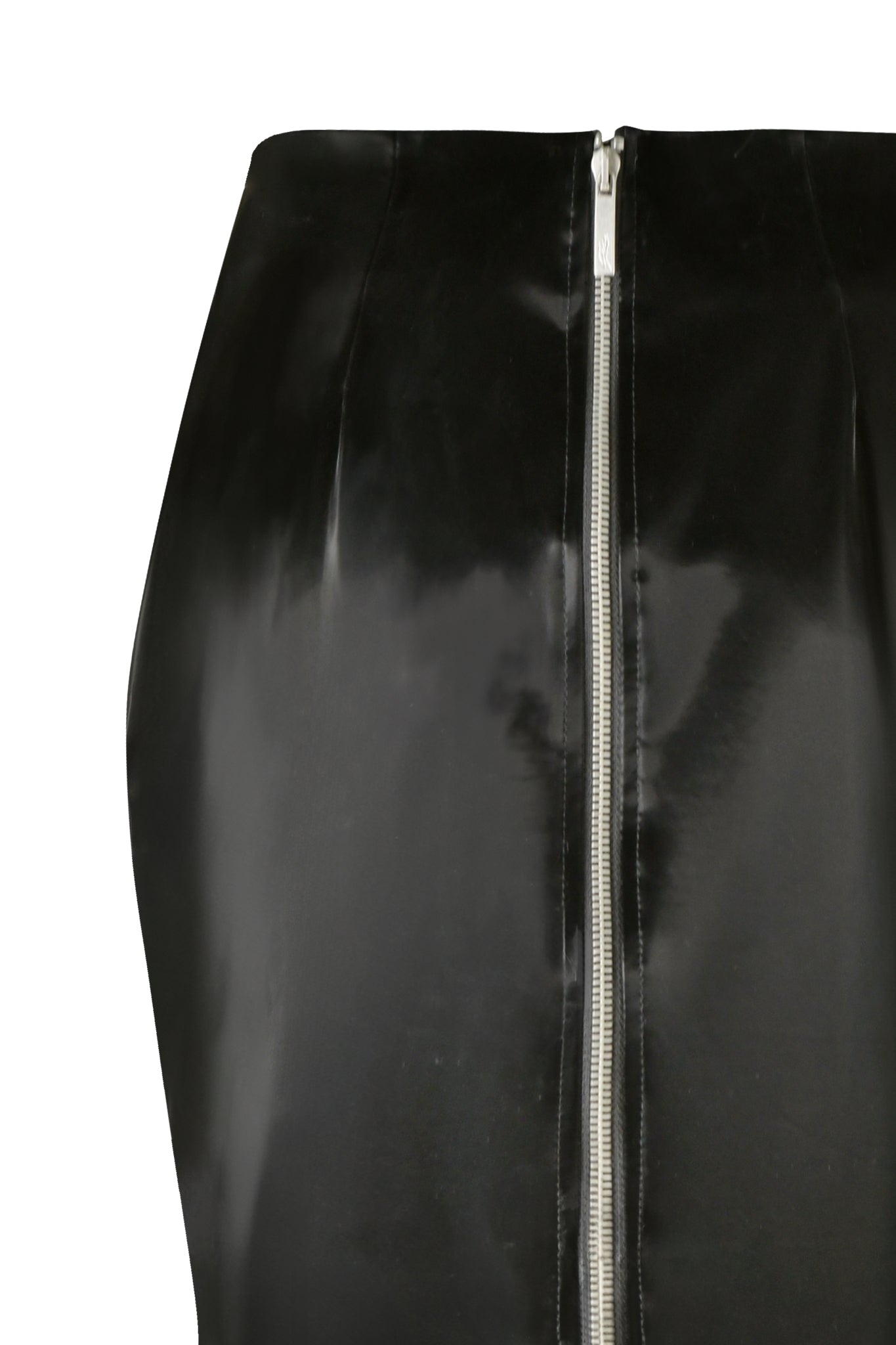 The CARMEN PENCIL SKIRT - BLACK by I.AM.GIA is a tight faux leather skirt showcasing a visible silver zipper running down the back. Its glossy texture reflects light, emphasizing its sleek and smooth appearance, with an image centered on the midsection of the skirt.