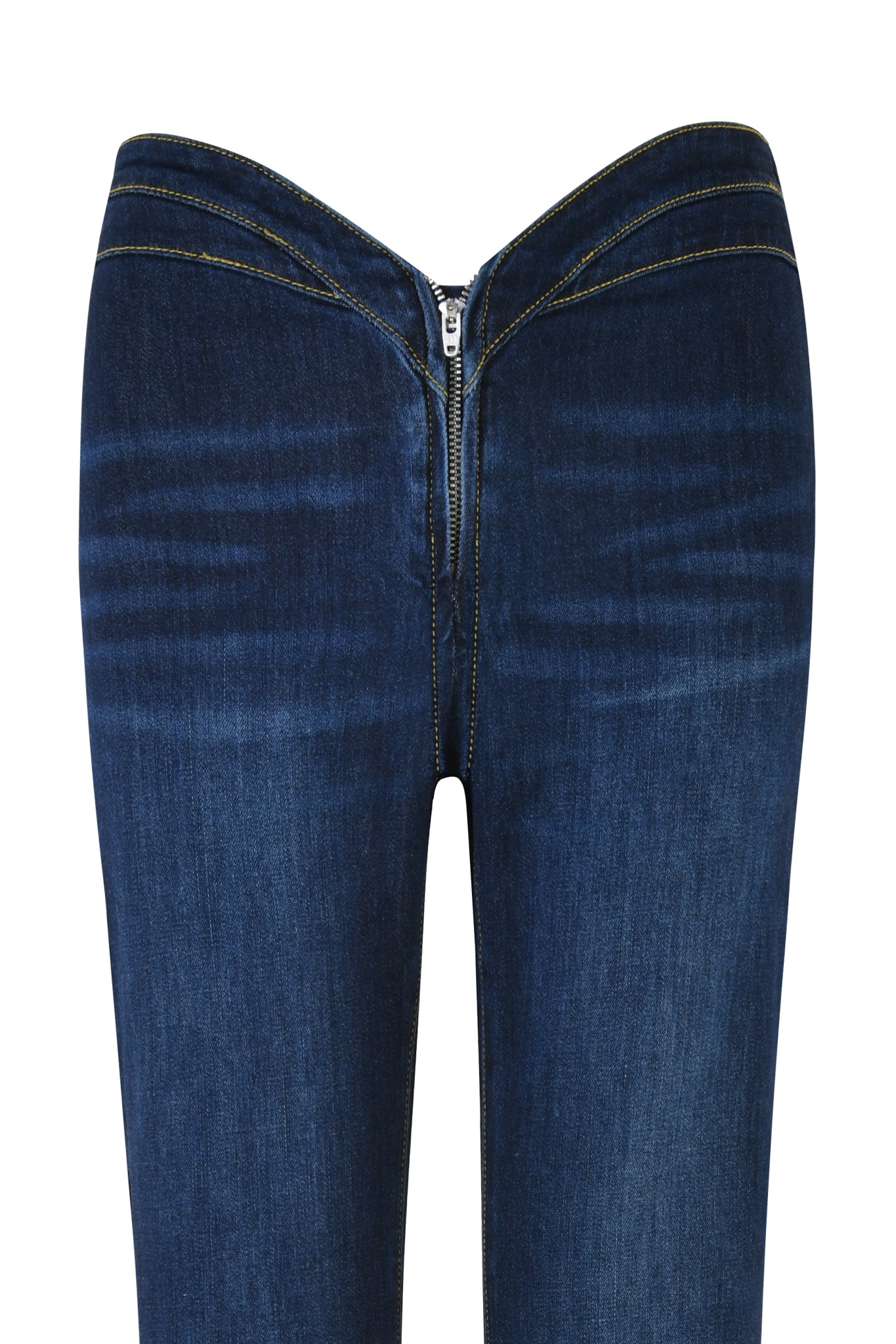 An image of the ELLENA JEAN 2.0 - BLUE : DARK WASH by I.AM.GIA showcases a pair of dark blue denim jeans, featuring visible light creases around the thighs and a prominent front zipper running from the waistband down to the crotch. The dark denim jeans are highlighted by yellow stitching along the seams and zipper area, with a subtle flared silhouette for added style.