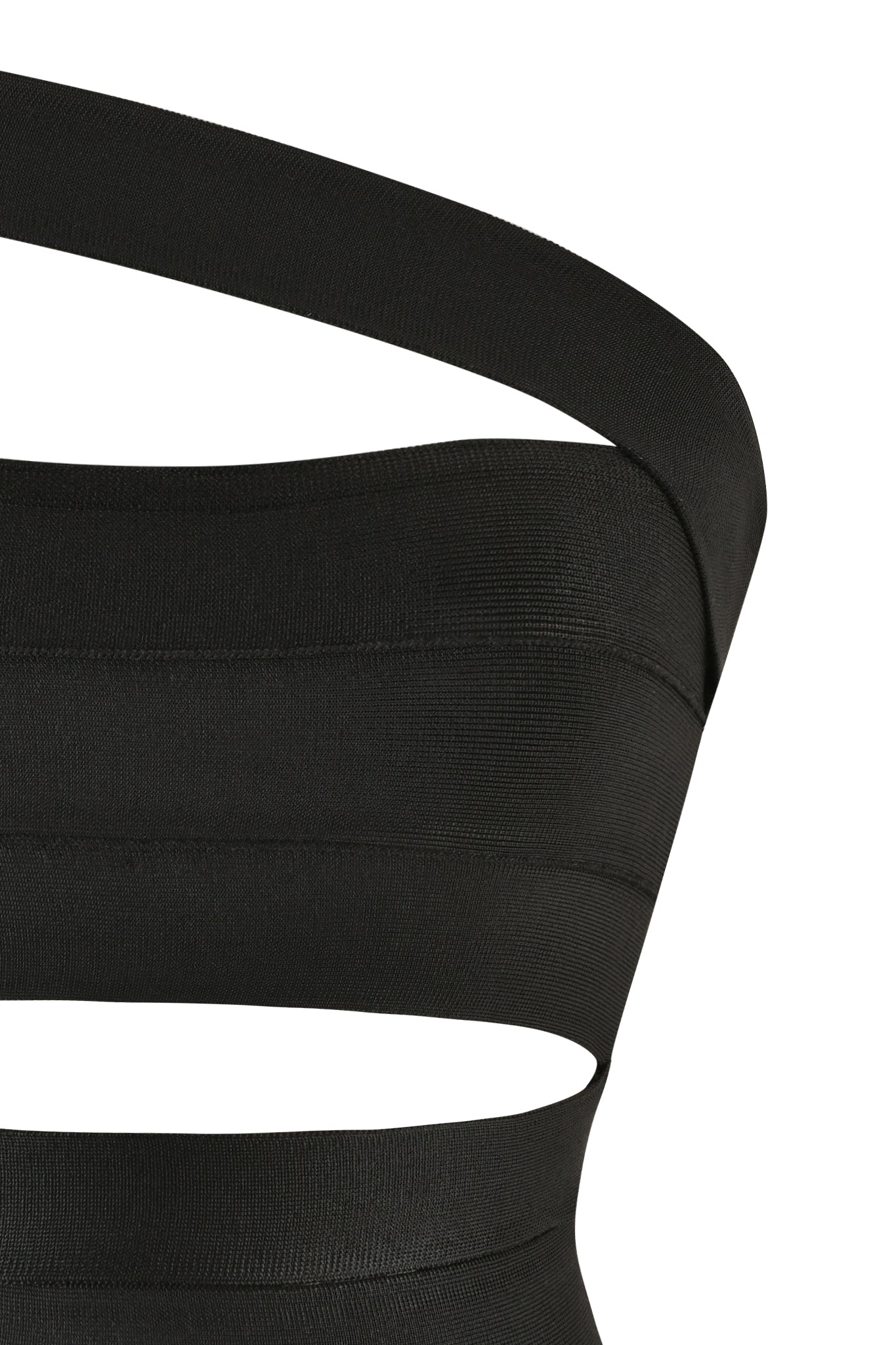 A close-up of the FLAVIA TOP - BLACK from I.AM.GIA. This ribbed, one-shoulder top showcases a unique cutout design at the waist and features detached straps, adding an edgy and stylish element to its sleek silhouette. The material appears stretchy and form-fitting.