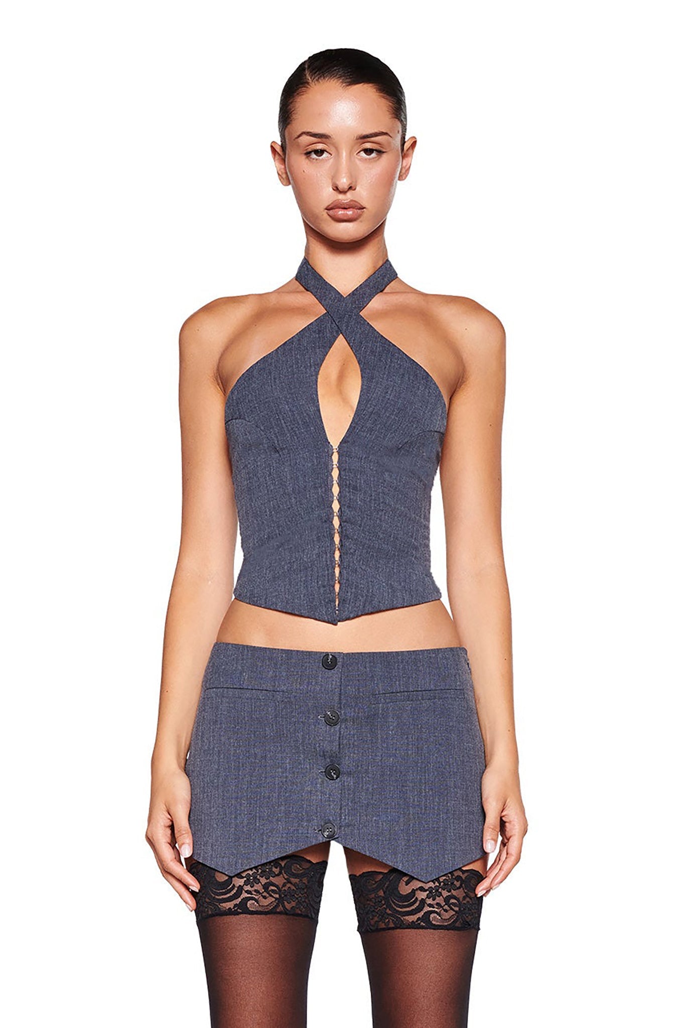 The ADRIETTE SKORT - GREY:PLAID by I.AM.GIA showcases a blend of style and functionality with its central belt featuring a metallic buckle and grommets. Expertly crafted from stretch suiting fabric, this mini-length skort boasts a subtle V-shaped notch at the top center, adding distinct design elements to its grey plaid pattern.