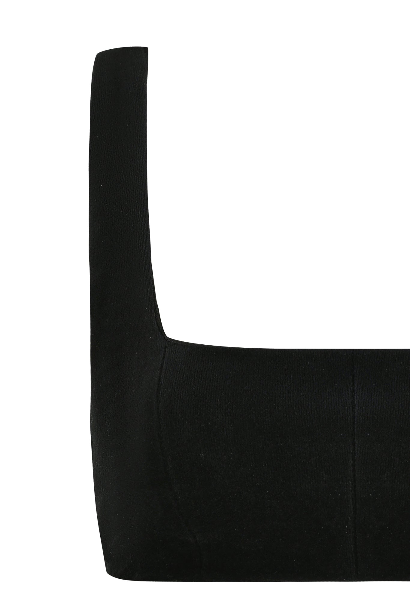 Close-up of the LAURA CROP TOP - BLACK by I.AM.GIA on a plain white background. The photo focuses on the left side of the top, showcasing the straight neckline and thick shoulder strap that hint at its bodycon silhouette.