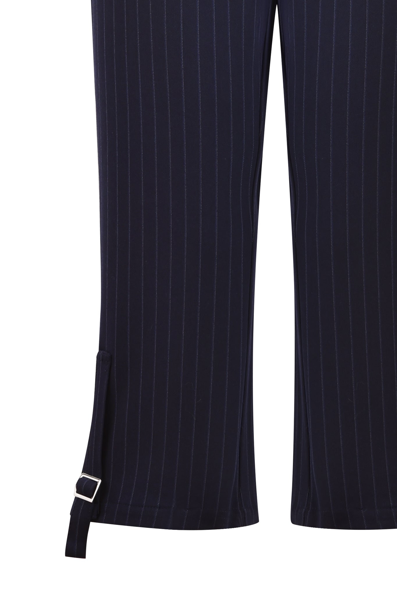 Close-up of the lower part of the MARRION CAPRI - BLUE : PINSTRIPE by I.AM.GIA, showcasing fine vertical stripes. These navy capris feature a strap with a small silver buckle near the bottom hem of each leg, enhancing the adjustable side straps and straight leg silhouette.