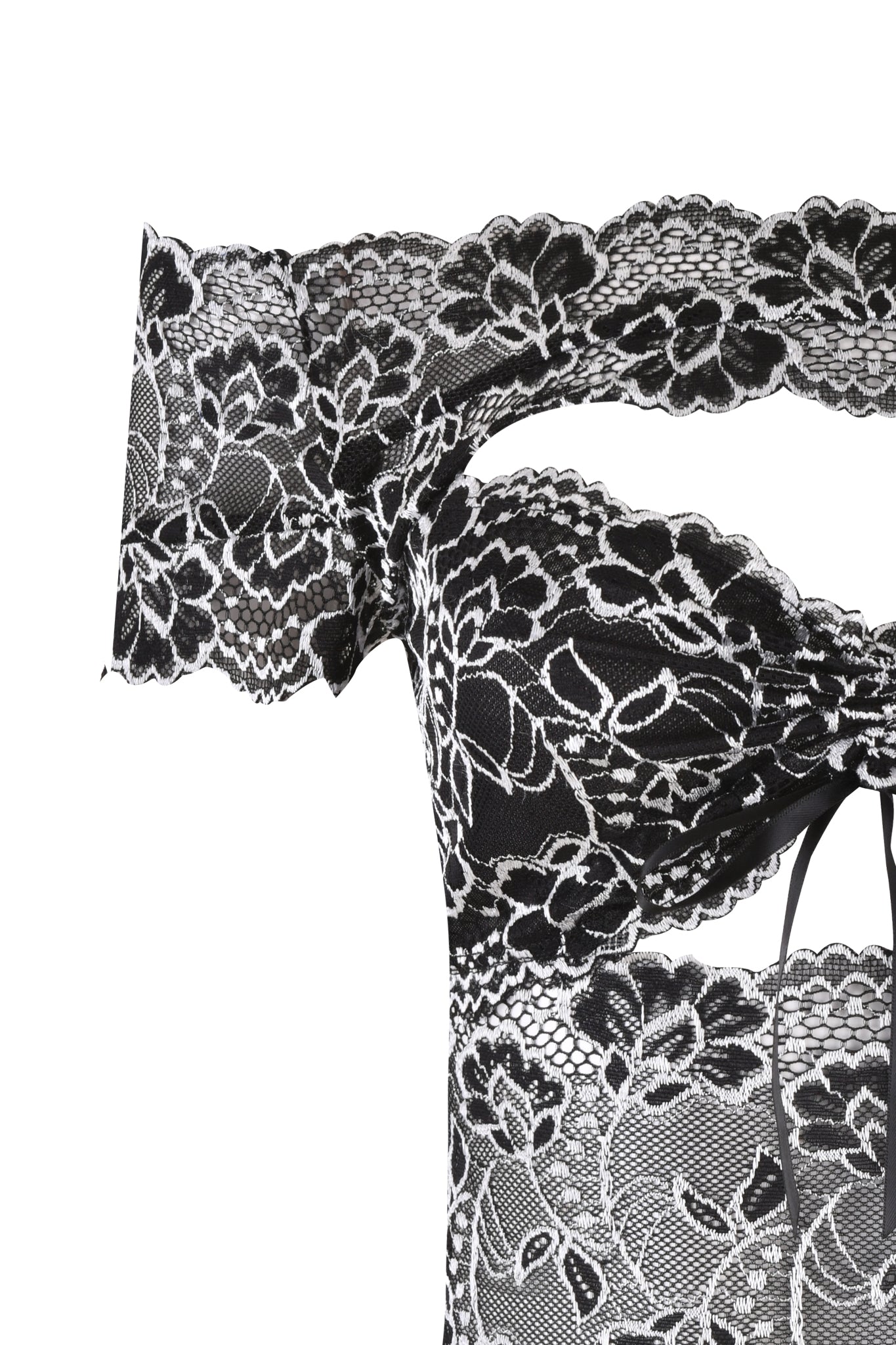 A detailed view of the CRYSTAL TOP - BLACK by I.AM.GIA, showcasing its elegant black lace fabric adorned with intricate floral patterns. This semi-transparent material emphasizes detailed embroidery and is styled in an off-shoulder bodycon fit with a central bow detail.