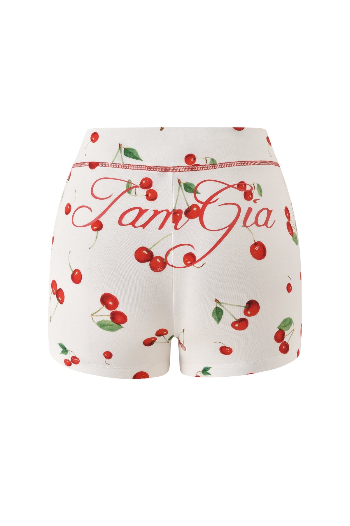 The BLARE SHORT - CHERRY ON TOP by I.AM.GIA showcases a lively cherry and lush green leaf pattern, highlighted by “I.AM.GIA” boldly scripted in large red cursive across the back. Complete with an elastic waistband, these mini shorts offer both comfort and statement style for summer.