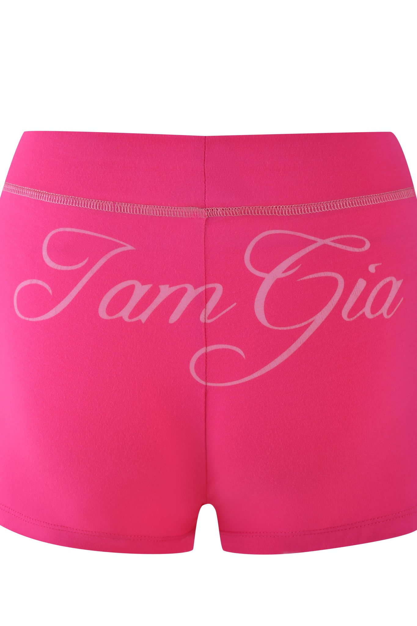 Hot pink BLARE shorts by I.AM.GIA, showcasing "I.AM.GIA" in bold white cursive on the back. The waistband features a stitched detail for a bodycon fit, and the smooth, stretchy fabric resembles bamboo jersey.