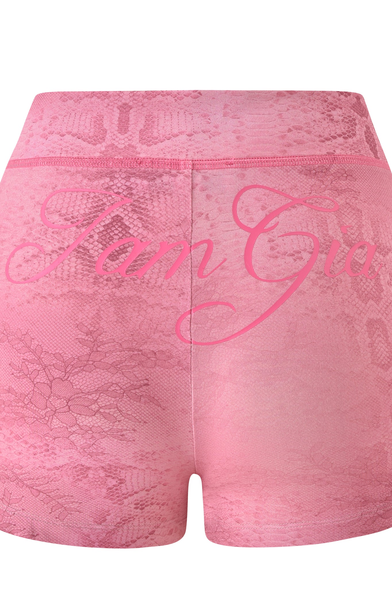The BLARE SHORT - LIGHT PINK SERPENTINE by I.AM.GIA features a high-rise fit and an elastic waistband, showcasing a subtle snake print in light pink. “I am Gia” is boldly scripted across the back in large cursive font, blending standout street style with a striking serpentine pattern.