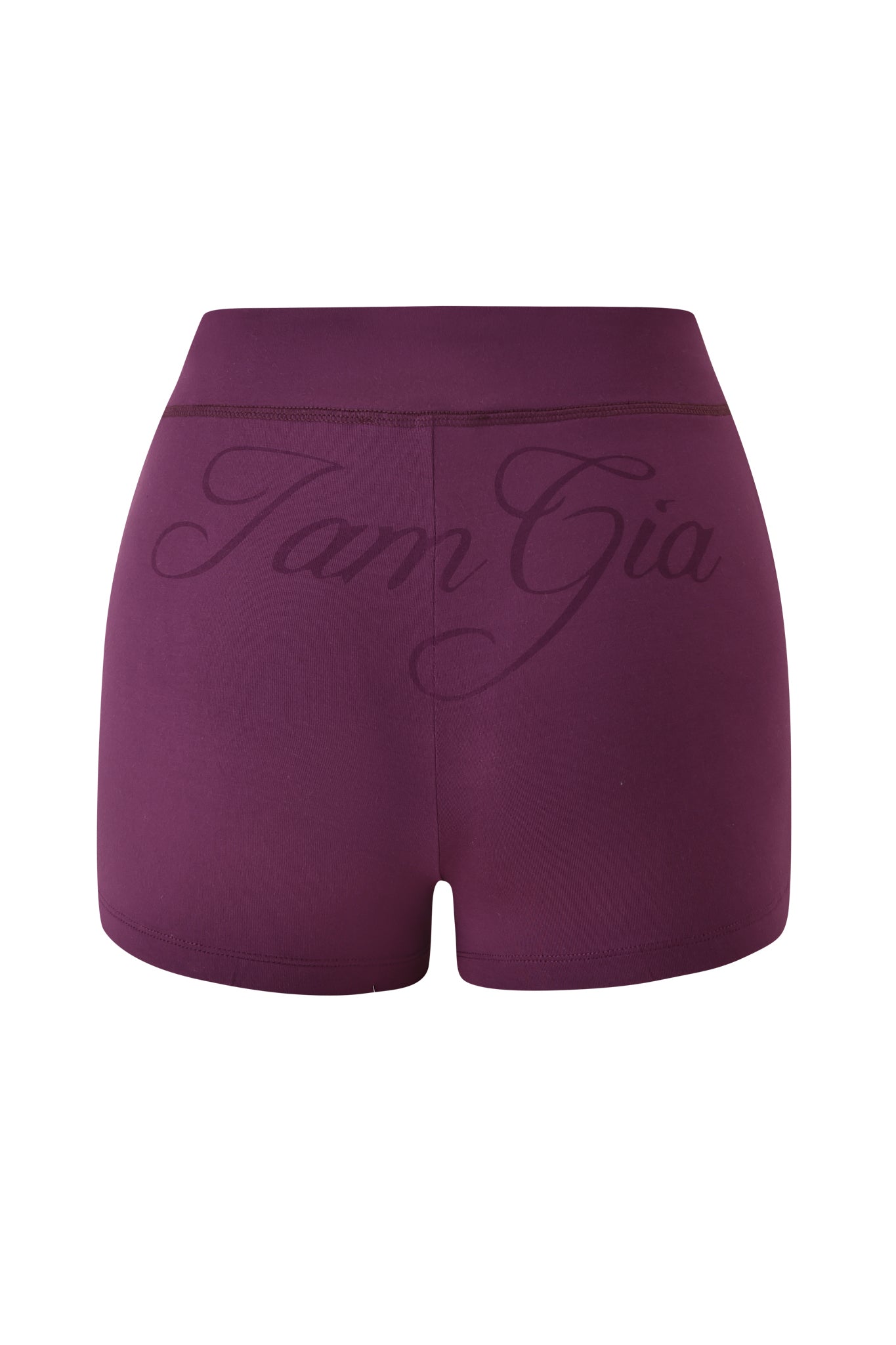 The BLARE SHORT - PLUM by I.AM.GIA is shown from the back, showcasing an elastic waistband with “I AM GIA” in large, cursive script across the waistband and upper section.