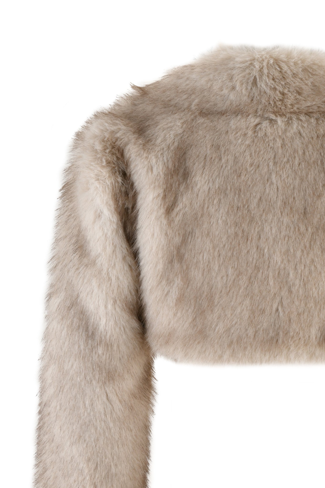 A close-up of the ALBA BOLERO - NEUTRAL : TAUPE by I.AM.GIA, highlighting the plush texture of its tan faux fur fabric. The image focuses on the shoulder and sleeve against a plain white background.
