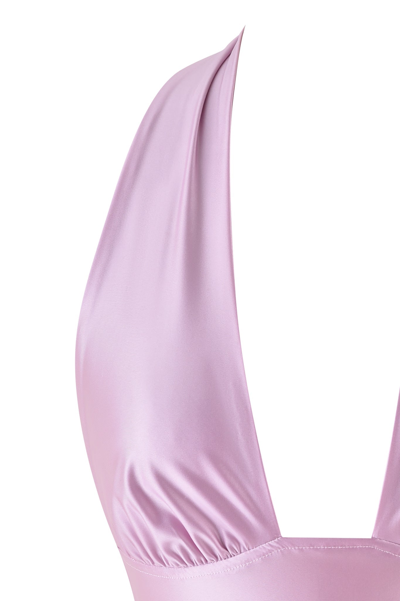 Close-up of the AURELIA HALTER TOP - PINK by I.AM.GIA. The baby pink silk fabric is smooth and shiny with a deep V-neck, emphasizing its chic bodycon fit and texture.