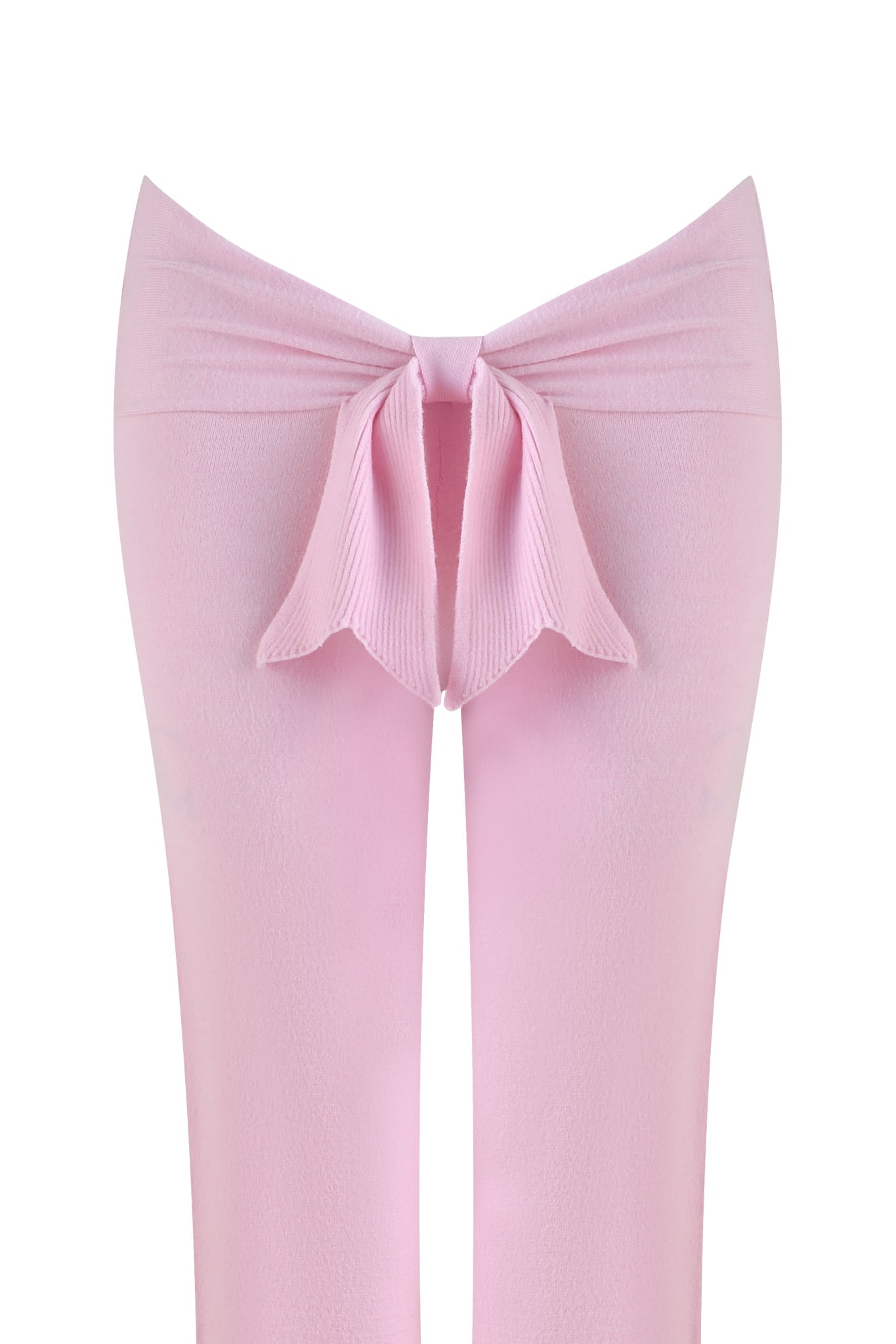 Close-up of ultra-soft knit fabric in delicate baby pink from the MORGANA PANT by I.AM.GIA, featuring a central seam detail creating a bow-like effect against a plain white background.