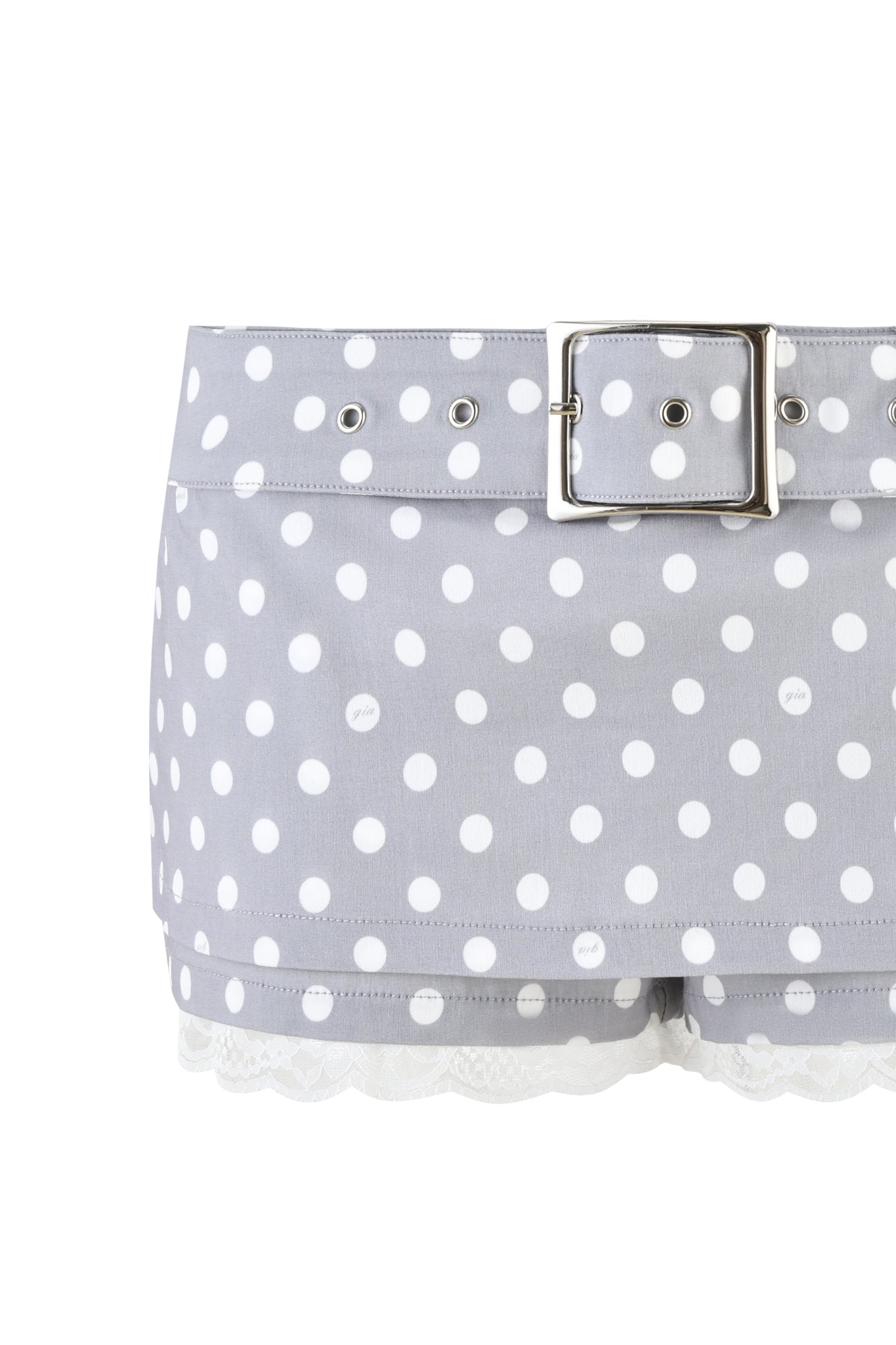 The MELDA MINI SKORT - GREY by I.AM.GIA features a playful gray polka dot design, complete with a sleek silver belt, eyelet band, and delicate lace trim for a touch of modern elegance.