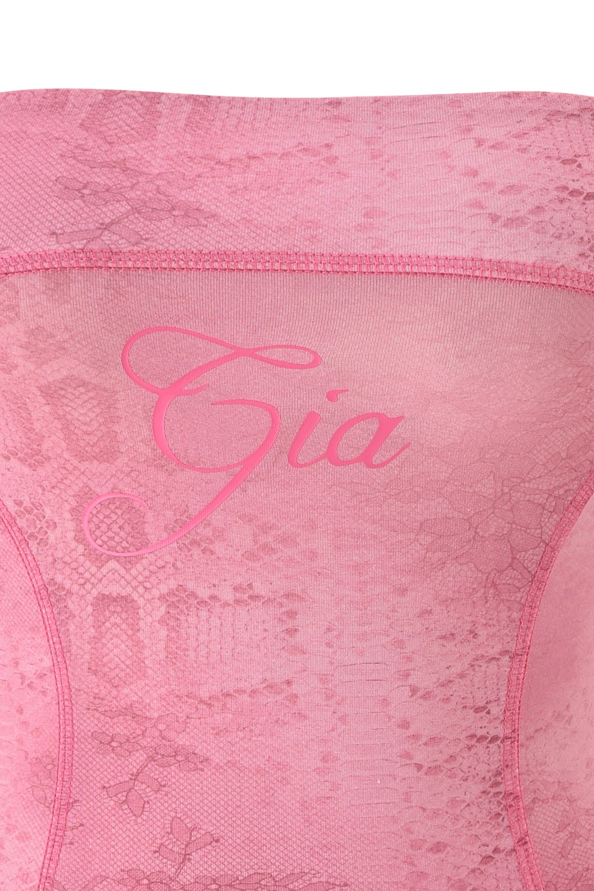 The BLARE BOOB TUBE - LIGHT PINK SERPENTINE by I.AM.GIA features light pink snake print lace fabric with a striking serpentine pattern and the “Gia” name elegantly scripted across the center in matching pink, embodying I.AM.GIA’s signature edgy style.
