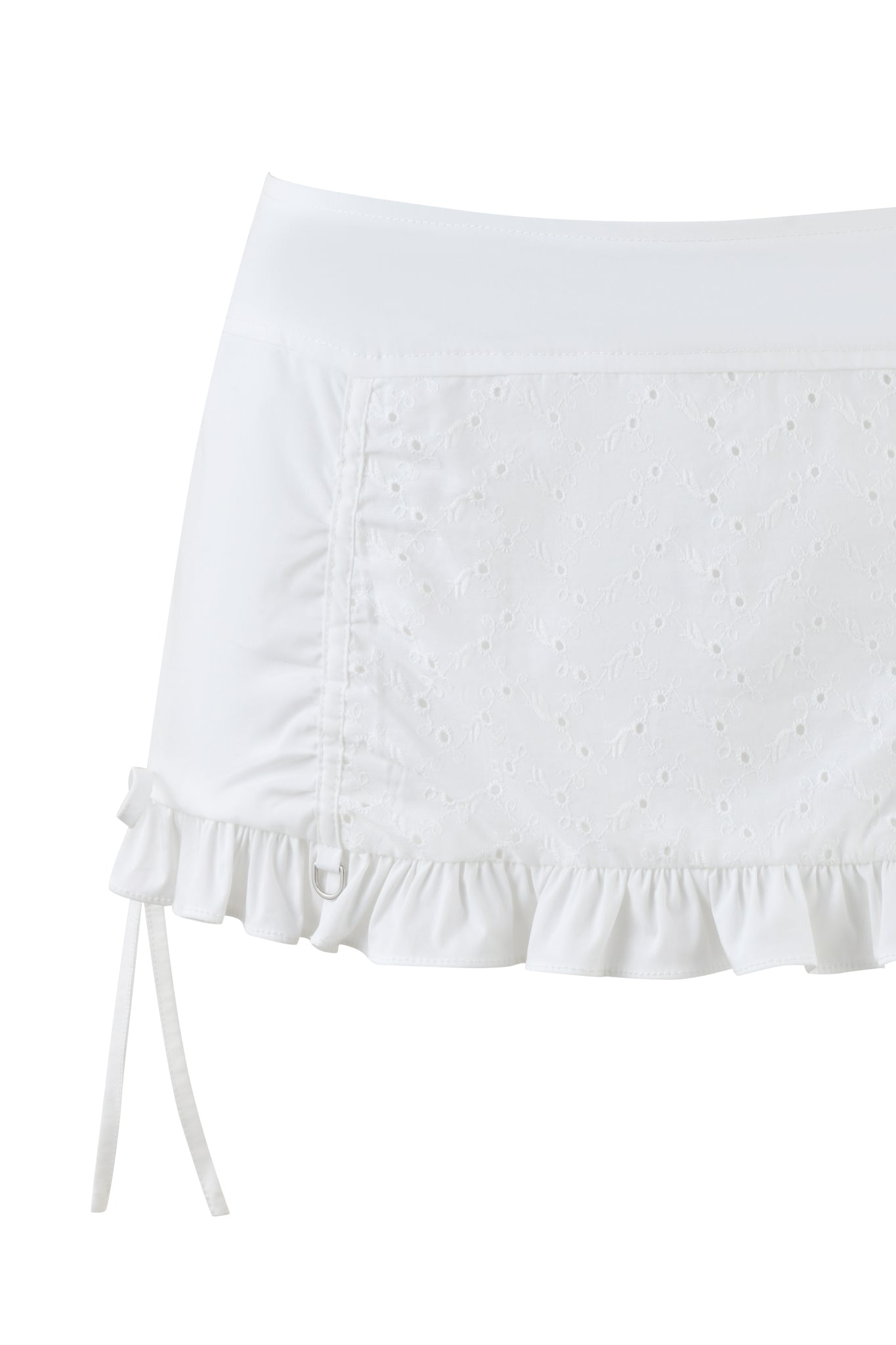 The WREN MINI SKIRT - WHITE by I.AM.GIA features a textured eyelet fabric with small patterns, a side drawstring, and a frilled hem. Its low-rise waist and slightly stretchy material give it a feminine and stylish look.