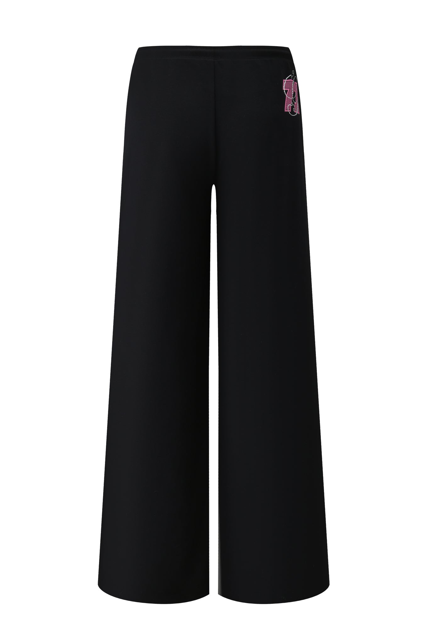 The I.AM.GIA ARLO TRACK PANT - BLACK features a high waist, wide-leg silhouette, and a small pink and beige patch on the right hip near the waistband. Shown from the back.