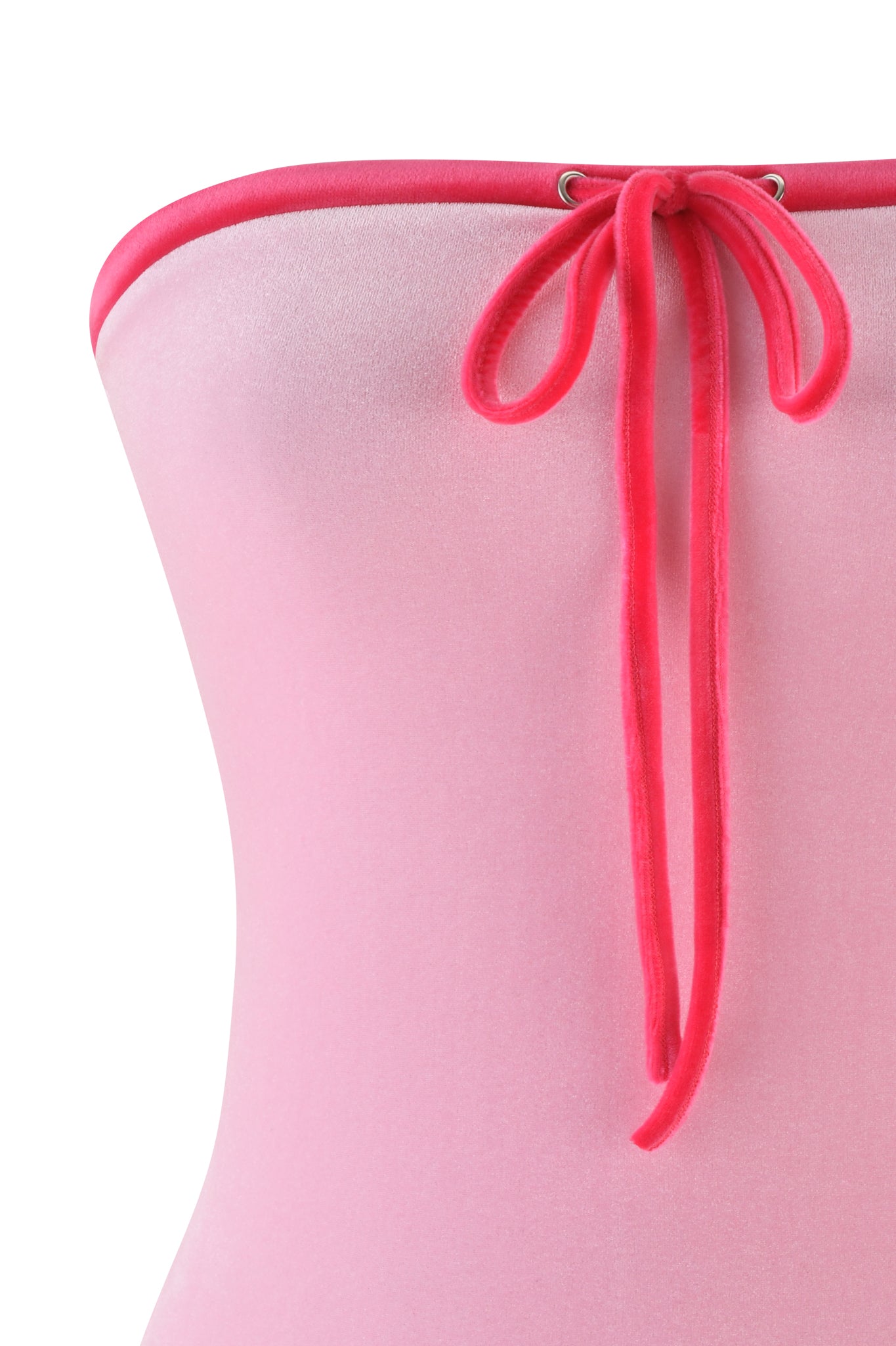 Close-up of the I.AM.GIA MICHELLE VELOUR BOOB TUBE in pink, featuring a shiny strapless design with a bodycon fit. A bright pink tie threaded through metal eyelets adds a playful touch to the neckline.
