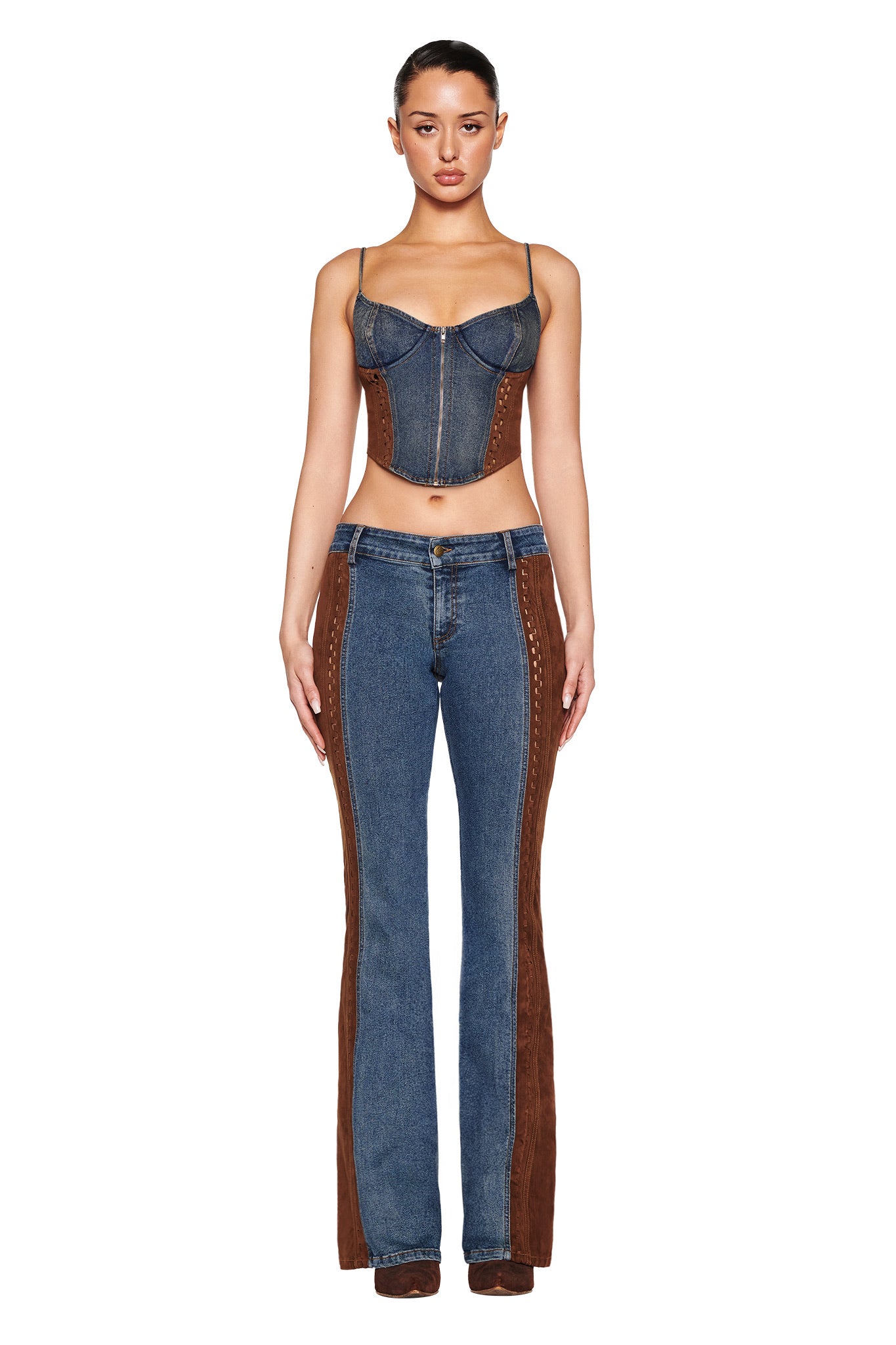 Against a white backdrop, a model exudes retro charm in a denim corset top and I.AM.GIA's FORREST PANT in blue medium wash, featuring brown suede contrast panels for understated sophistication.