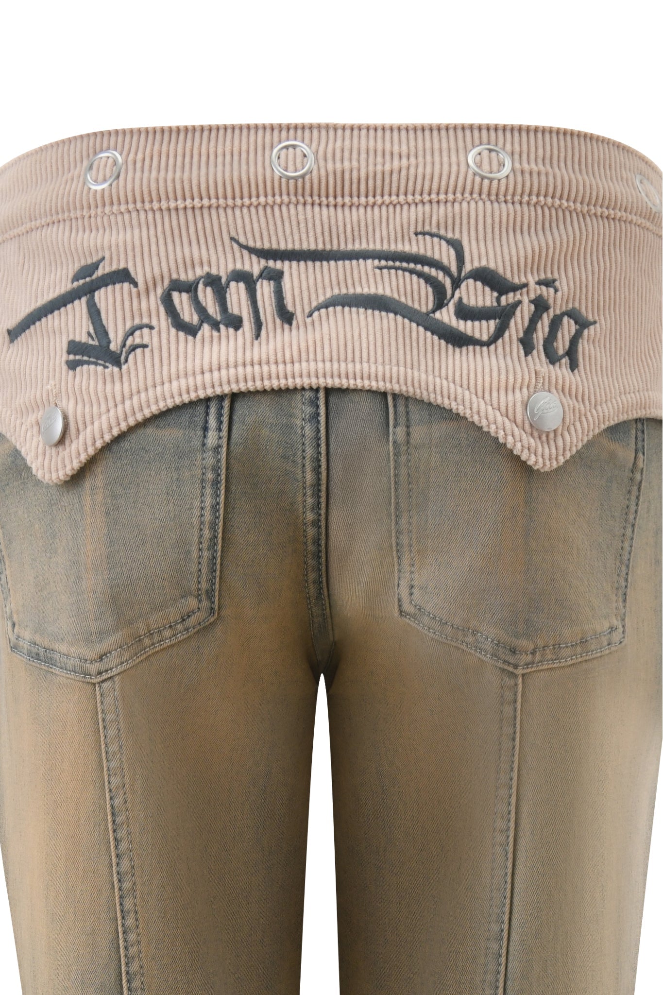Close-up of the I.AM.GIA TOMMIE JEAN - ANTIQUE DENIM, featuring a beige ribbed waistband and black "I am Gia" embroidery above two back pockets, showcasing the chic mid-rise fit.