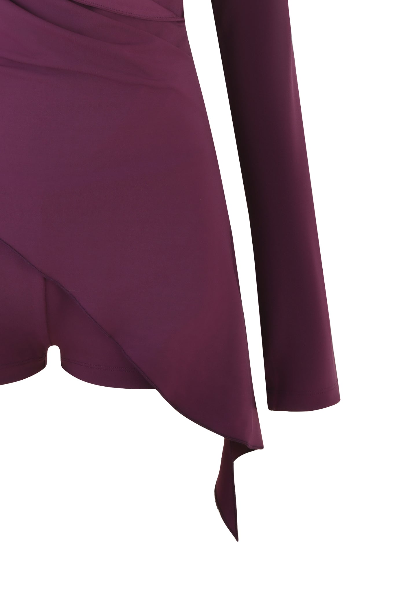 Close-up of the I.AM.GIA Irina Playsuit in Plum. This deep purple piece boasts an asymmetrical hem and long sleeves. Its smooth fabric drapes elegantly against a white backdrop, exuding sophisticated allure.
