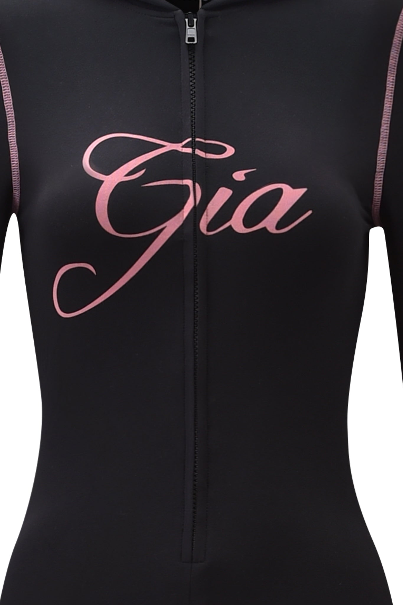 A close-up of the BLARE JUMPSUIT - BLACK by I.AM.GIA, featuring a black long sleeve hooded design with "Gia" in large pink cursive letters across the chest.