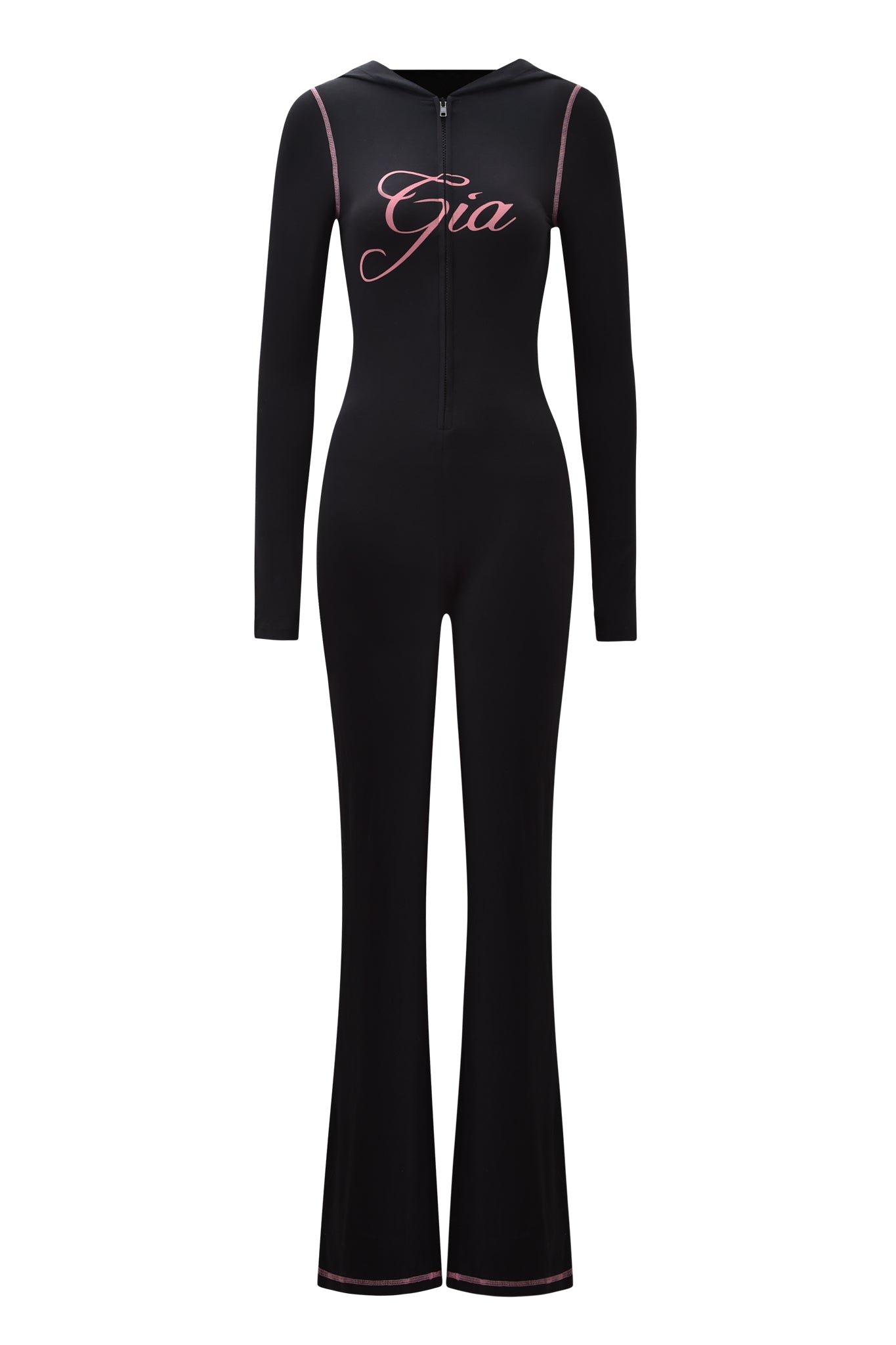 The BLARE JUMPSUIT - BLACK by I.AM.GIA is a black, fitted long-sleeve jumpsuit with flared legs, a front zipper, pink seam and hem stitching, and "Gia" in pink script on the chest.