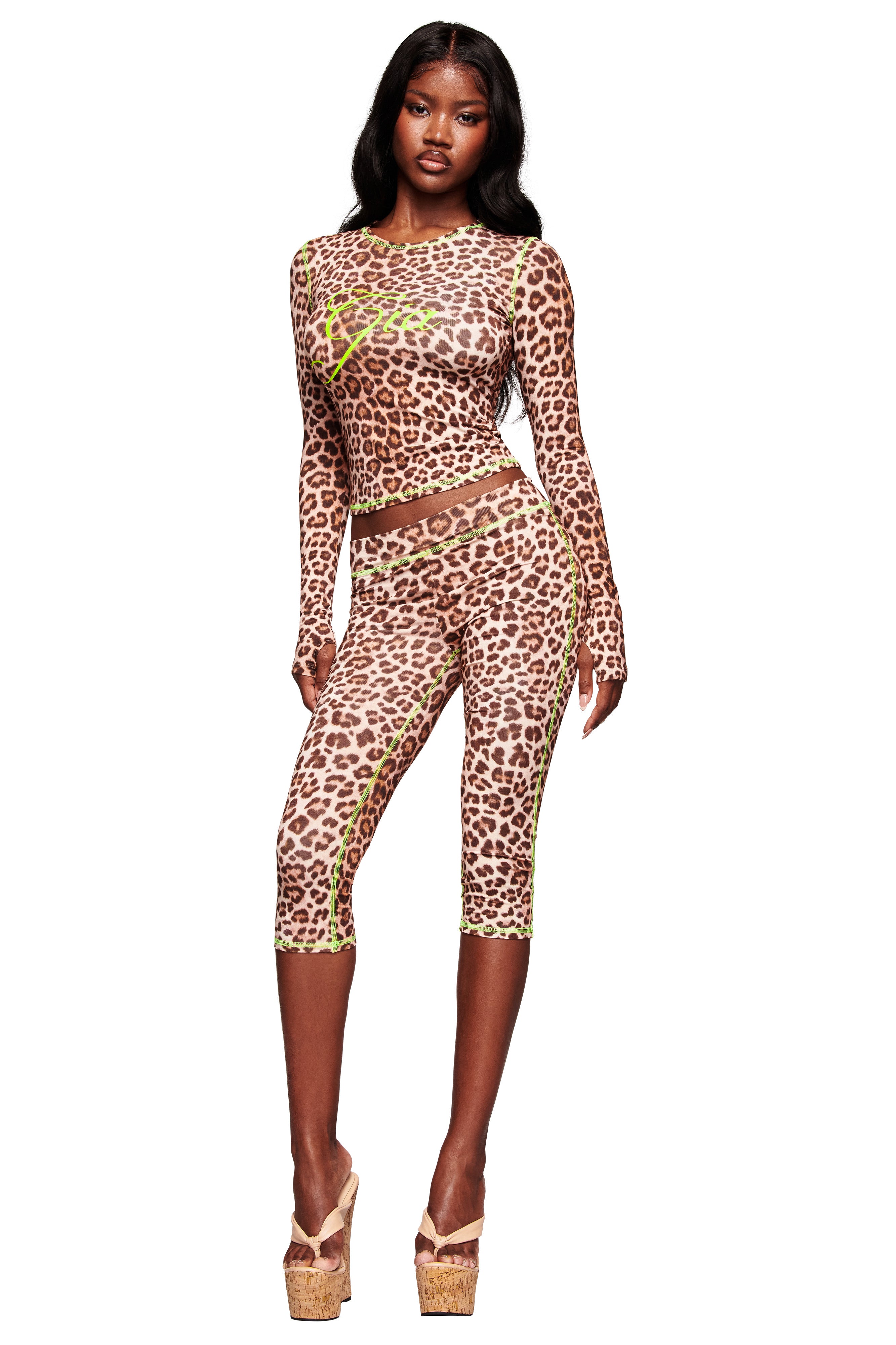 A woman wears the I.AM.GIA BLARE CAPRI - LEOPARD, flaunting a bold, bodycon fit.
