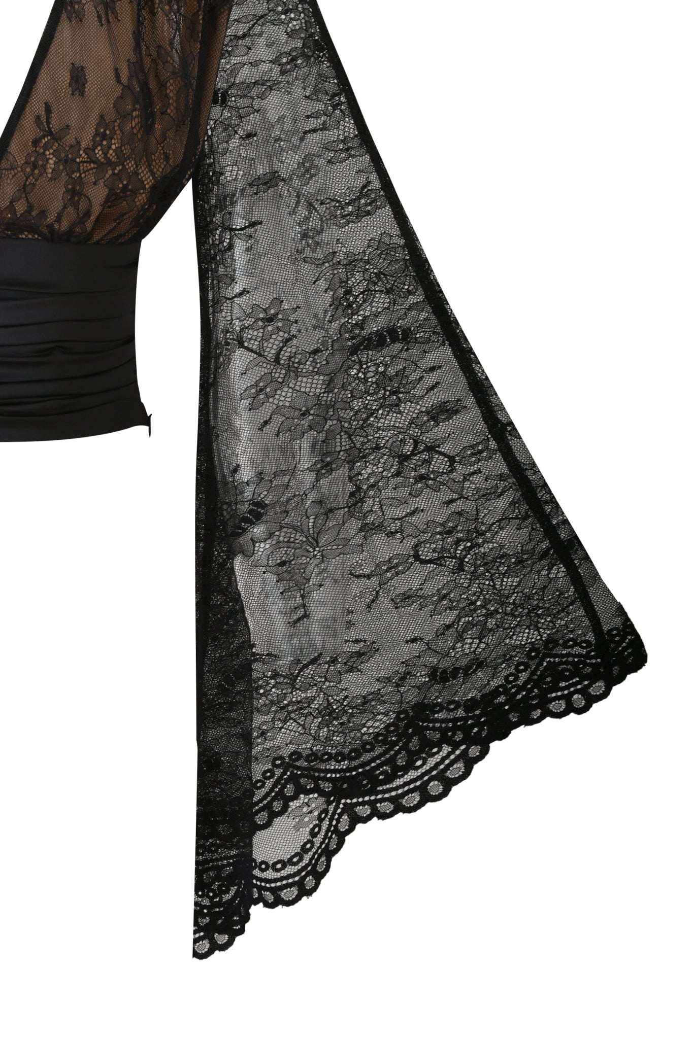 Close-up of the STEVIE TOP - BLACK by I.AM.GIA, featuring sheer black lace with a floral pattern and scalloped edge, highlighting its draped, intricate detailing and elegant sleeve design.