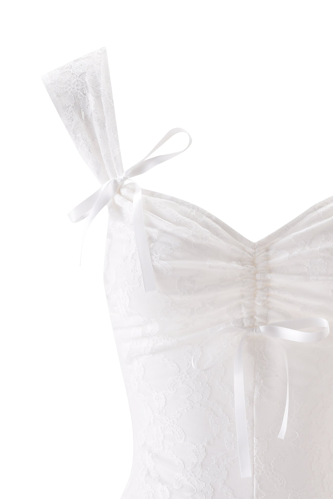 Close-up of the SONNET PLAYSUIT - WHITE by I.AM.GIA, featuring white lace, a sweetheart neckline, ruched bust, and two white ribbon bows—one on the shoulder strap and one at center front.