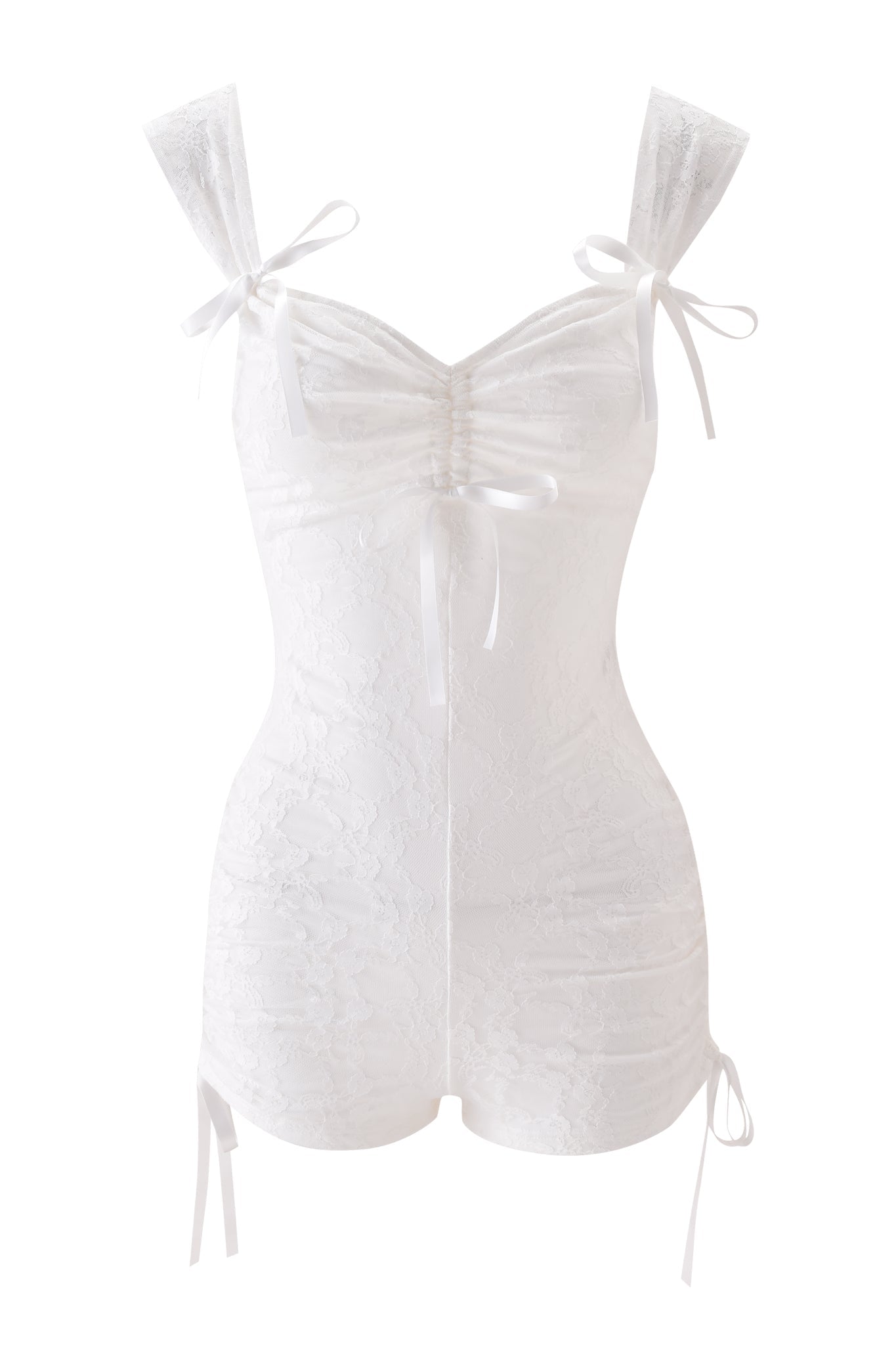 The SONNET PLAYSUIT - WHITE by I.AM.GIA is a fitted, sleeveless romper with white lace, ruched front, adjustable shoulder ties, and bows on the straps and hips. Features a sheer floral pattern with romantic feminine detailing.