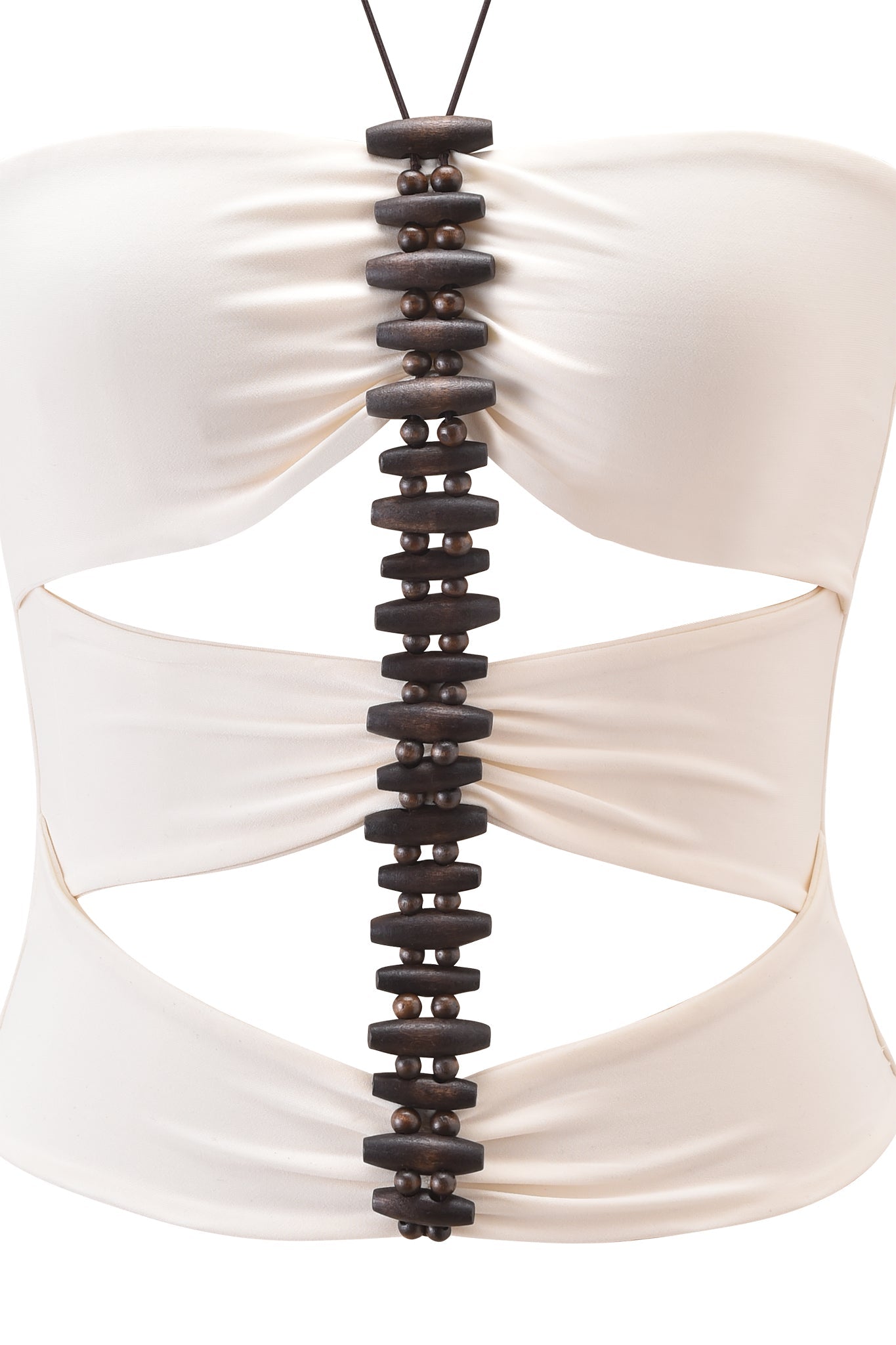 A close-up of the I.AM.GIA FENNICK TOP - OFF WHITE, a bodycon fit with side cutouts, showcasing a central vertical row of dark wooden beads and discs connected by a black cord.