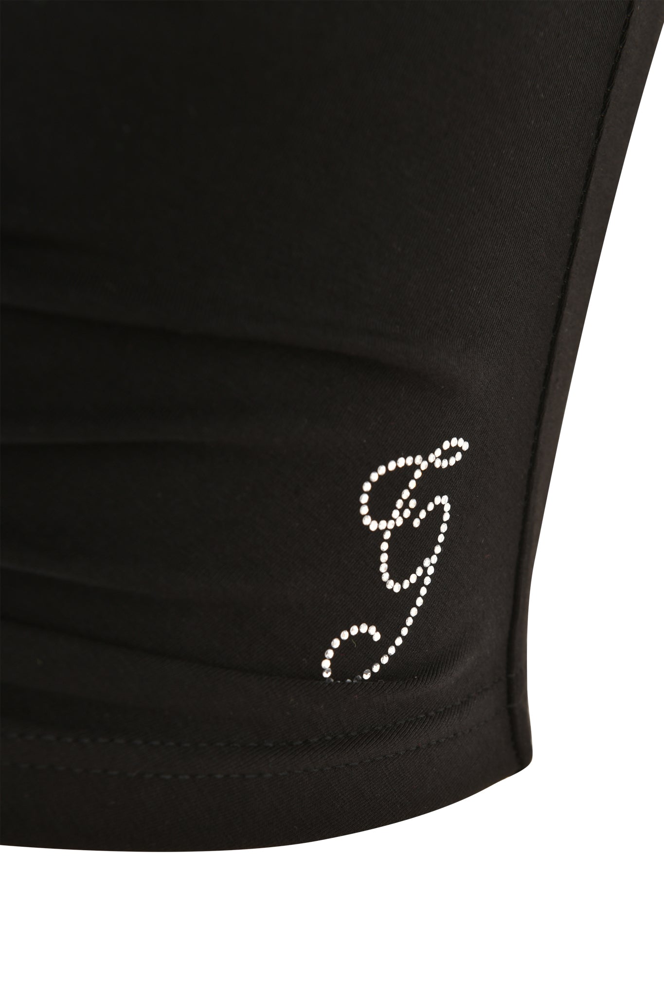 Close-up of the HALO TOP - SOLID BLACK by I.AM.GIA, featuring a cropped halterneck design with a decorative "g" in small rhinestones on the lower side.