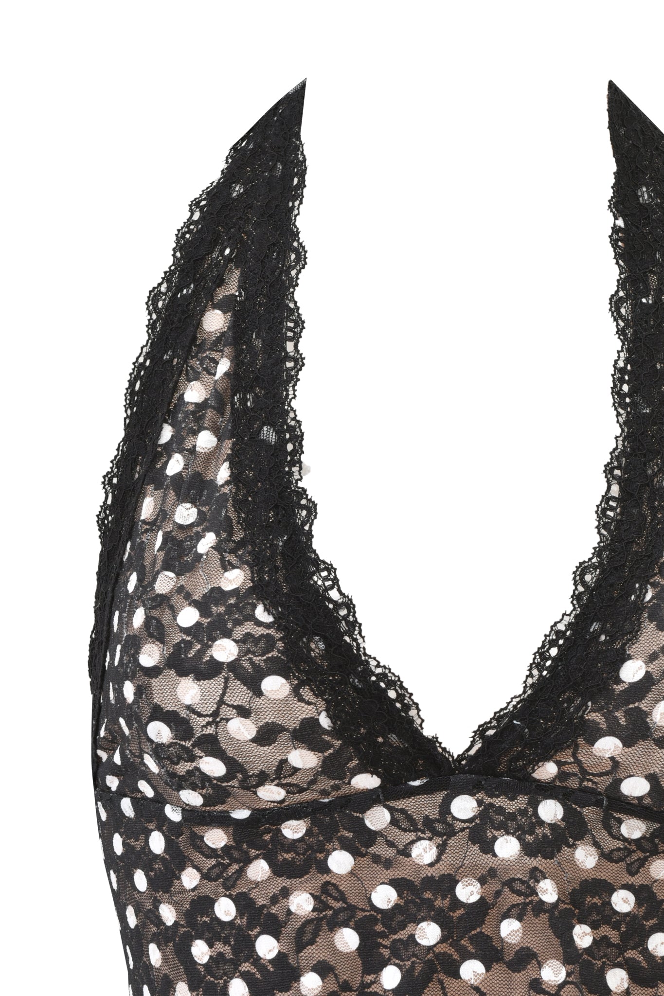 A close-up of the I.AM.GIA GEM HALTER TOP - BLACK POLKA DOT, featuring sheer polka dot fabric, a deep V-neckline, and scalloped lace trim along the edges.