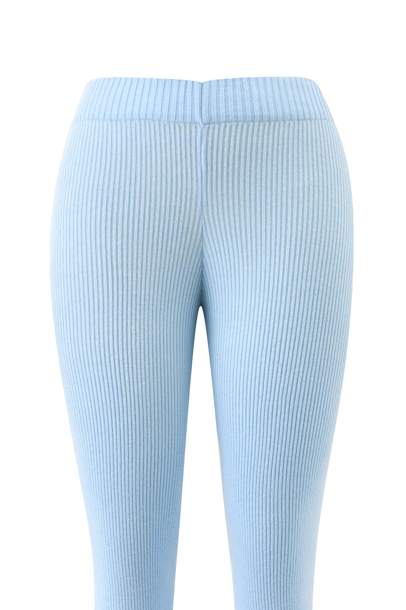 The BLARE KNIT TRACKPANT - BLUE by I.AM.GIA is shown from the back, featuring a high waistband, close-fit stretch fabric, and all-over vertical ribbing—a stylish update to classic blue knit trackpants.