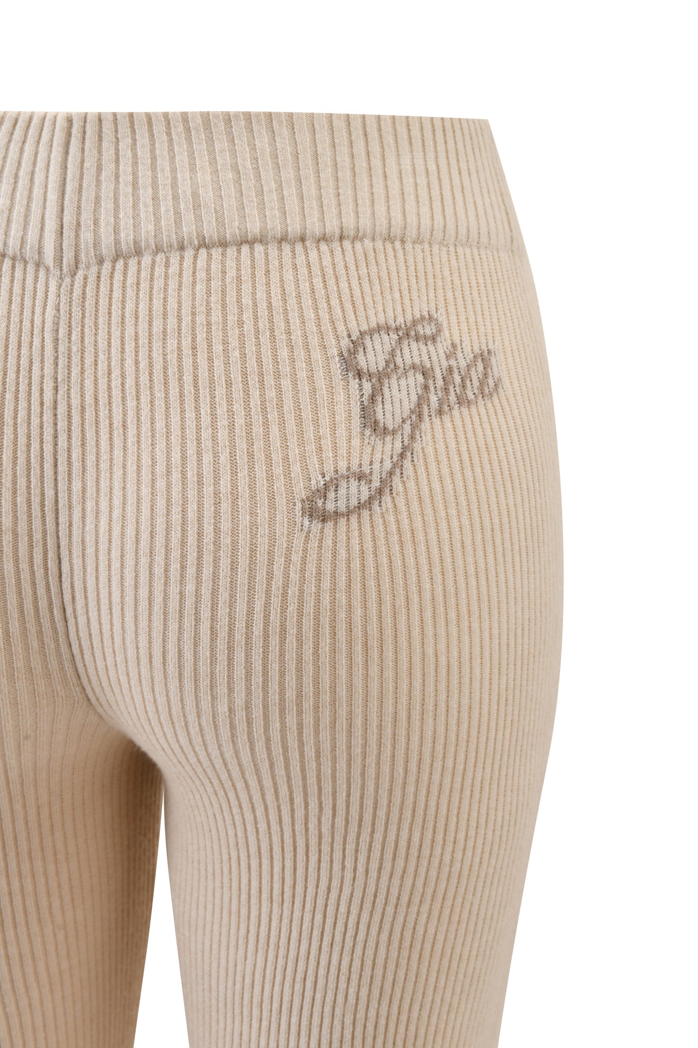 Close-up of BLARE KNIT TRACKPANT in cream by I.AM.GIA, featuring ribbed fabric and “Gia” embroidered in cursive on the waistband at the upper back hip.