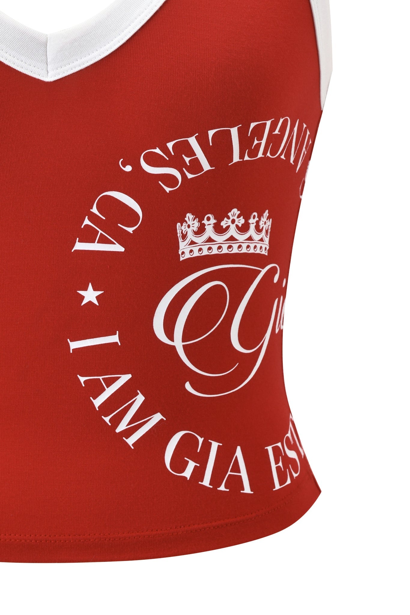 A close-up of the BLARE BIND TANK in red by I.AM.GIA, featuring white trim, a crown, and “GIA. I AM GIA EST ANGELS.” arranged in a circle on the front.