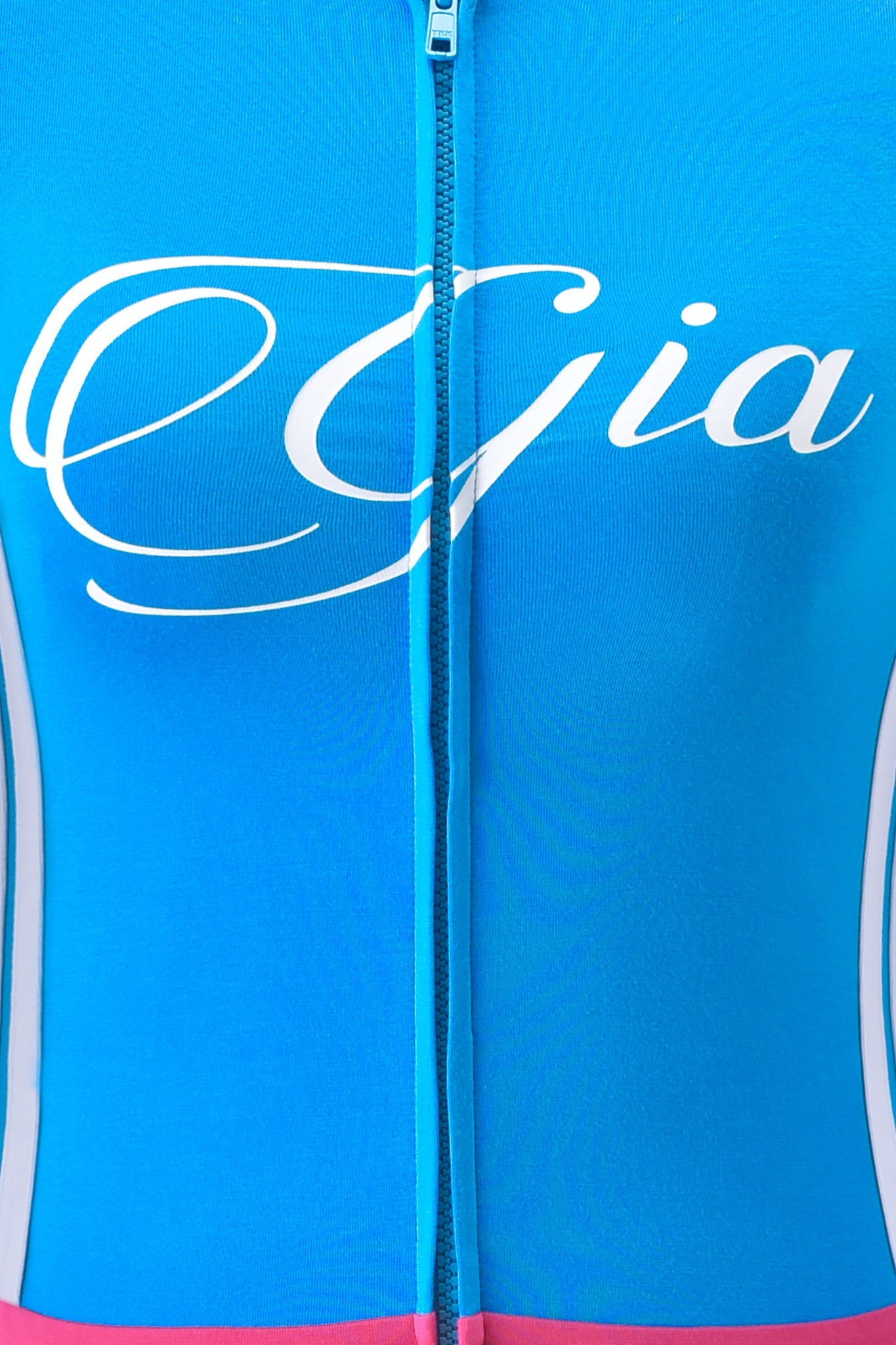 Close-up of the BLARE STRIPED HOODIE - SKY BLUE by I.AM.GIA, featuring "Gia" in white script across the chest, light blue side panels, and a pink accent at the hem for a fresh, modern look.